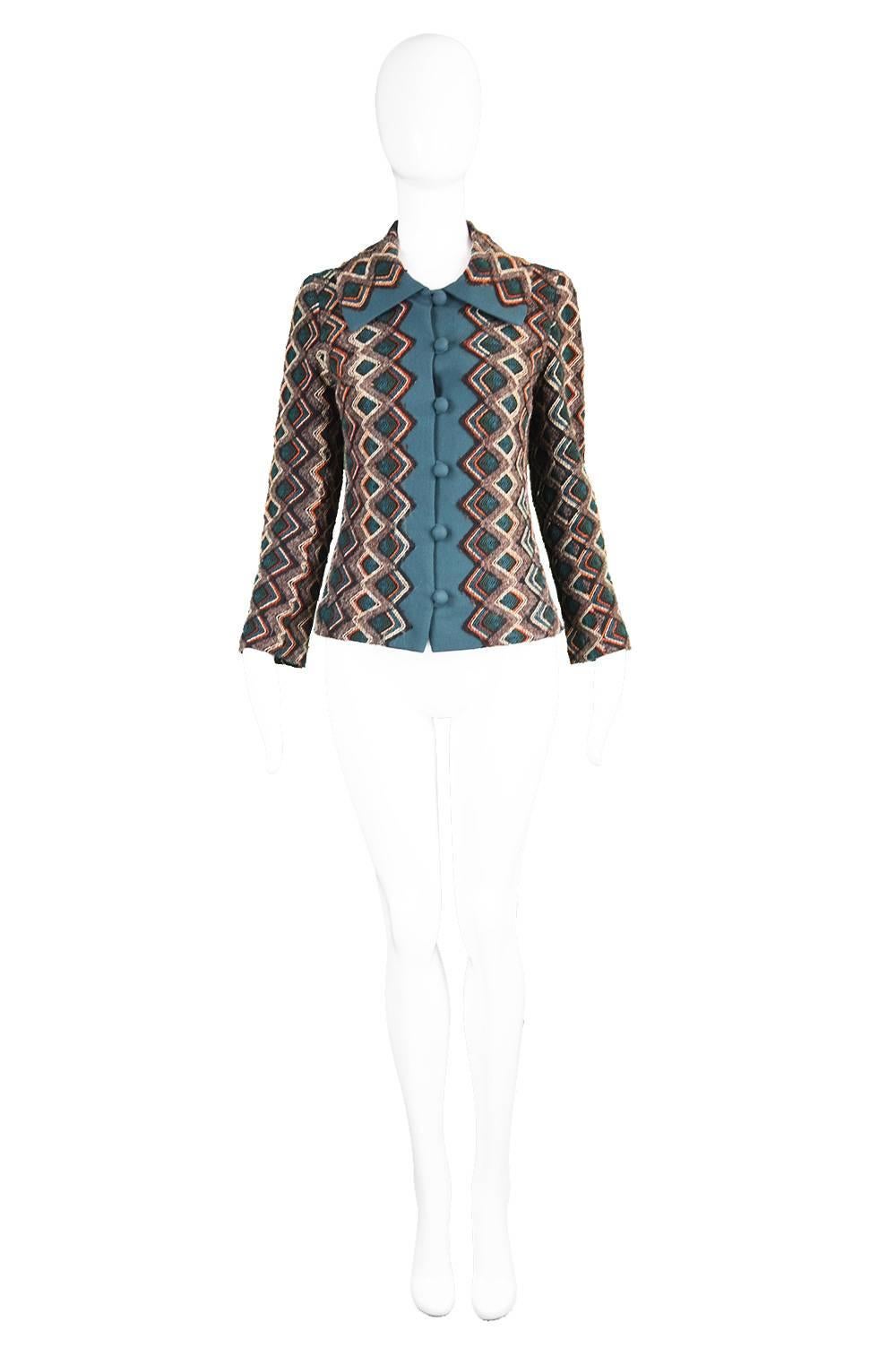 A chic vintage jacket from the 60s by British couturier and Royal dressmaker, Norman Hartnell for his 'Le Petit Salon' label. With a multicoloured, diamond-shaped woven wool tapestry style body and a wool crepe trim fabric on the collar, down the
