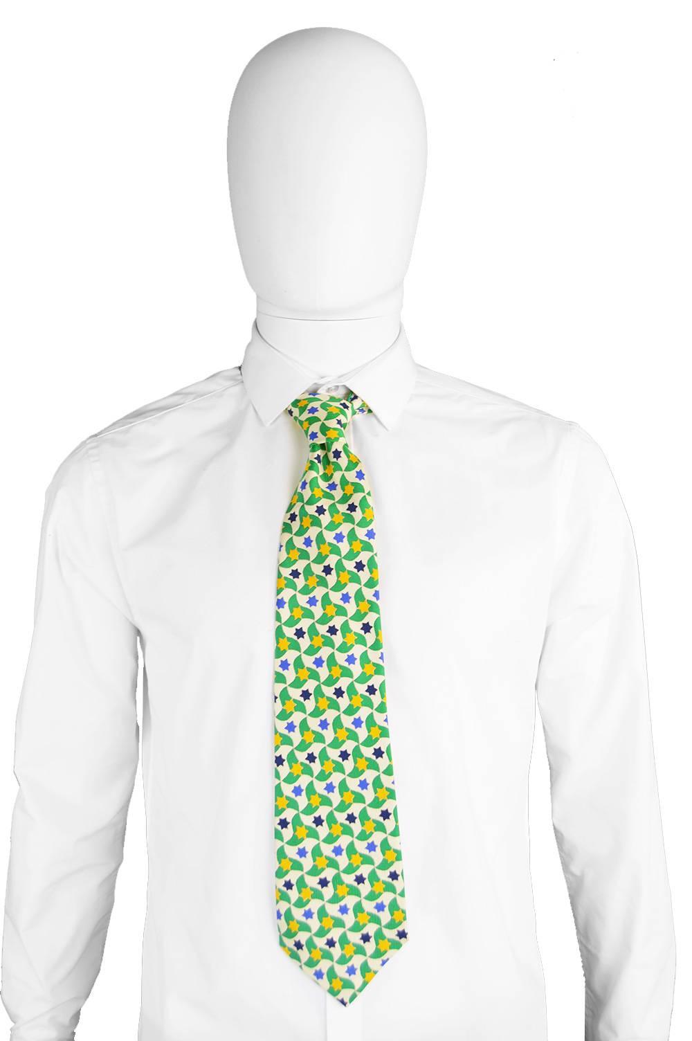 An eccentric vintage mens necktie in a pure silk by French designer, Yves Saint Laurent. Fits with 70s trends, so stylish and fun, it would make the perfect gift for him. With a green and star print throughout. 

Length - 56” / 142cm
Width (at