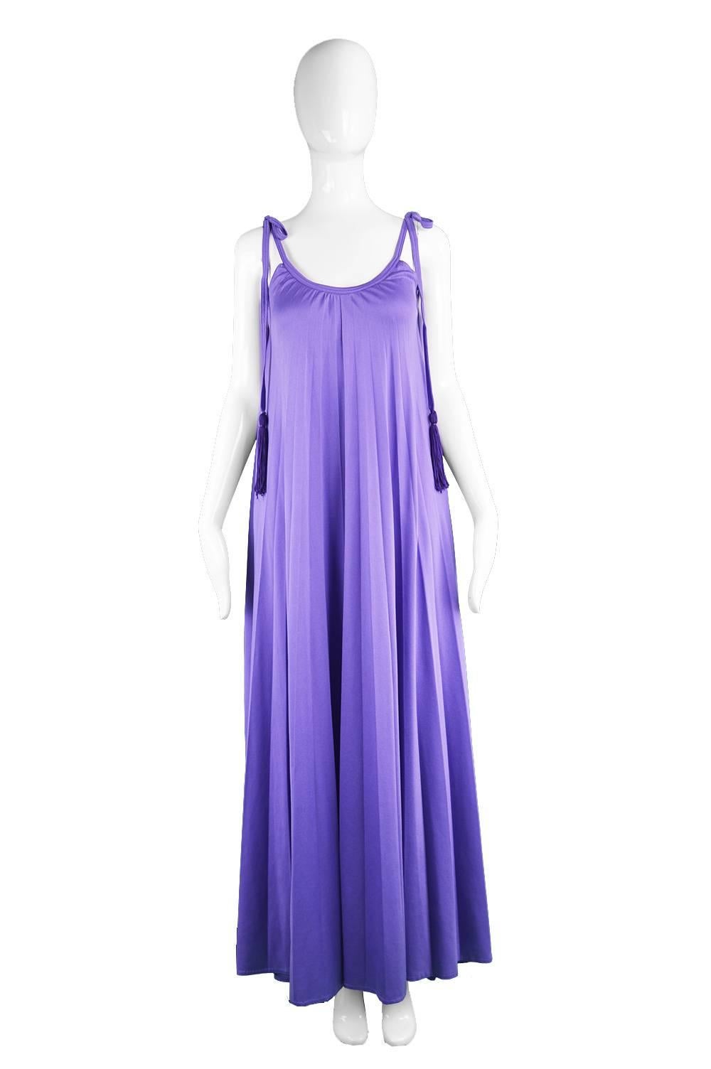 A breathtaking vintage evening gown from the 1970s by iconic British label, Frank Usher,. In yards of the incredibly flattering, fluid, synthetic jersey that Frank Usher is renowned for using in the 70s because it drapes so perfectly. A vibrant