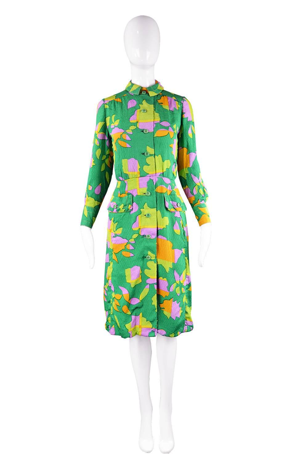 A gorgeous vintage dress by legendary American designer, James Galanos for Amelia Gray of Beverly Hills. In a fabulous green textured silk with a vibrant, tropical/ abstract print throughout. With topstitching highlighting the collar and cuffs and