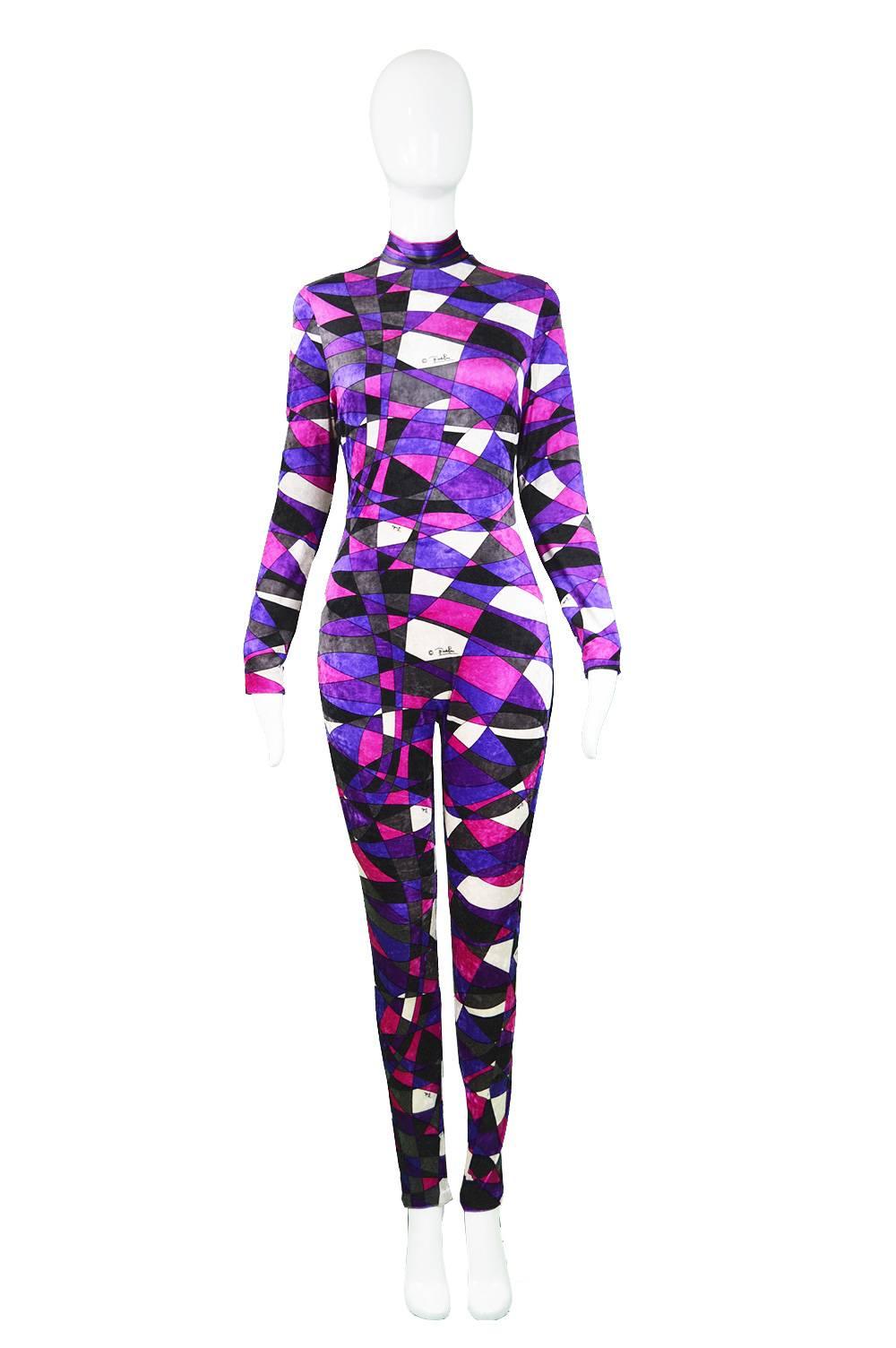 An incredible vintage Emilio Pucci jumpsuit/ catsuit c. 1970s in a stretch velvet/ velour in a kaleidoscope of pinks, purples, blues and whites with Pucci's signature throughout. An incredibly rare piece for Pucci collector's makes the perfect