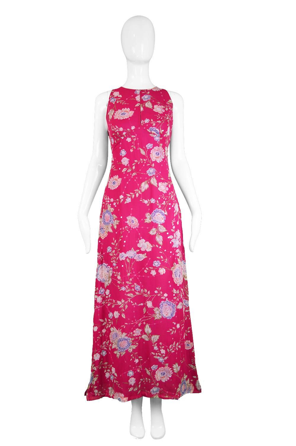 An elegant and feminine vintage maxi dress from the 1990s in a fuschia pink silk with an Asian/ Chinese style floral print throughout. Perfect for day or evening, this gorgeous sleeveless dress has a subtle keyhole at the bust to add a flash of