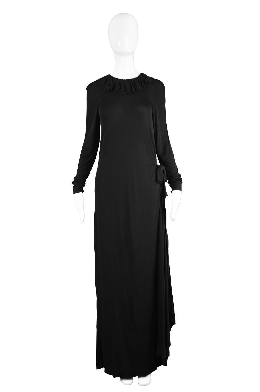 An incredible vintage Jean Muir column maxi dress from c. the late 1970s in a slinky black rayon jersey with a playful ruffle collar, a long elegant cut with clean lines creating the sophistication that Miss Muir was known for and a glamorous side