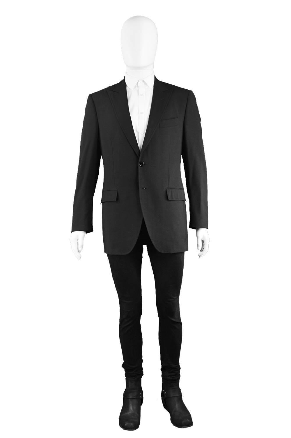 A classic men's blazer or dinner jacket by luxury Italian designers, Dolce & Gabbana for their mens mainline, circa A/W 2005. With peak lapels, flap pockets and in a classic black wool with 