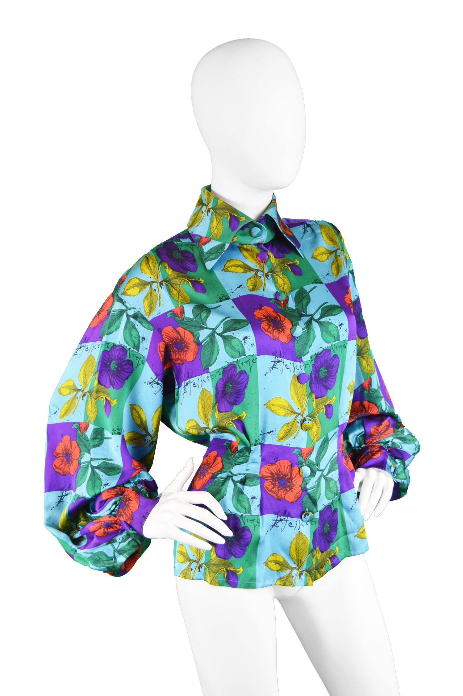 A stunning vintage women's blouse from the 90s by luxury French designer, Christian Lacroix. With huge, voluminous sleeves that add a sense of drama and shows the luxurious fluidity of the silk. The shirt is printed with a bold turquoise, purple and