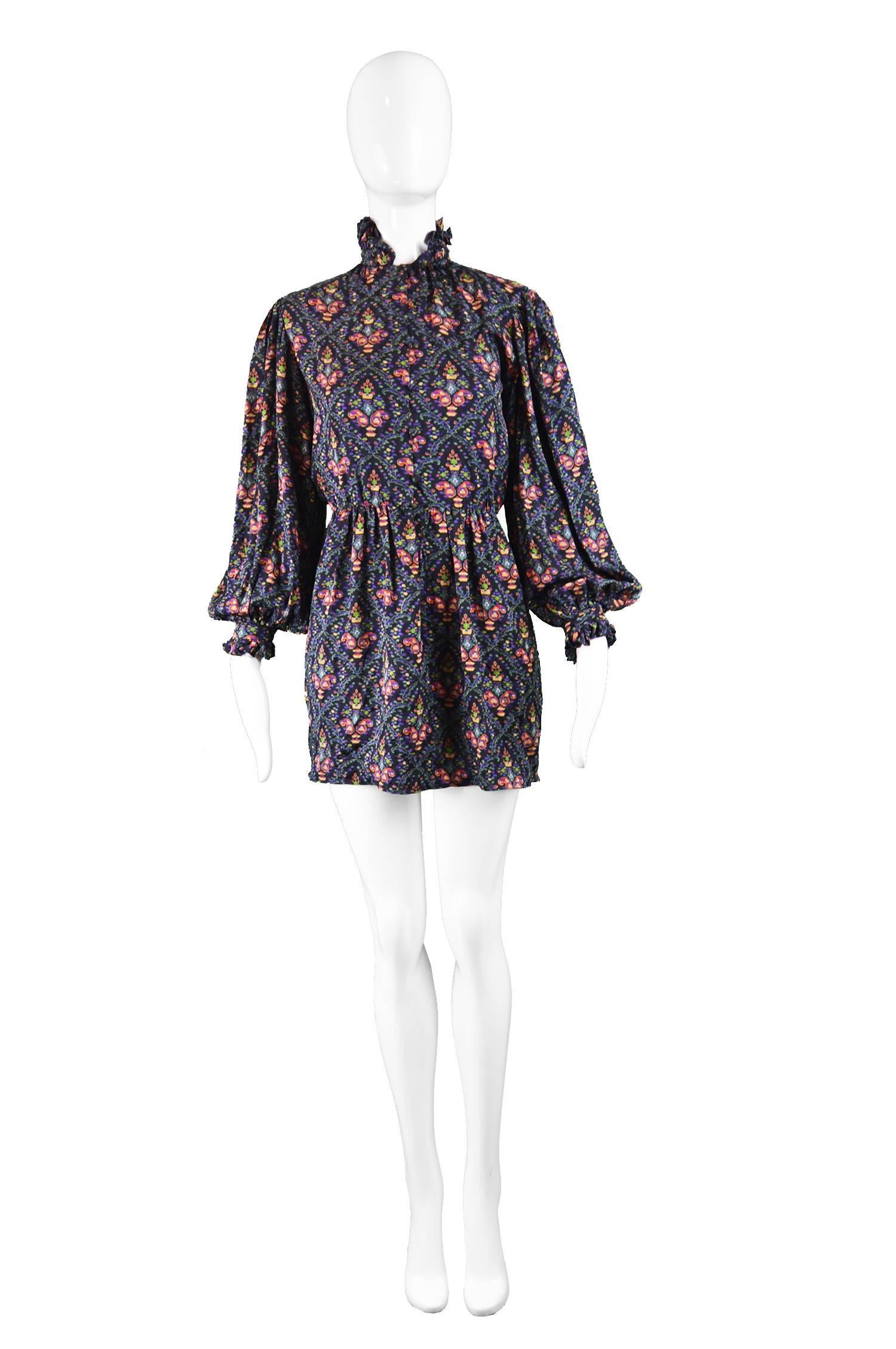 A beautiful vintage women's mini dress from the 70s by American luxury designer, Oscar de la Renta. In a light and airy black silk with a bohemian floral tapestry style print throughout. The silk really gives fluidity and drape to the dramatic