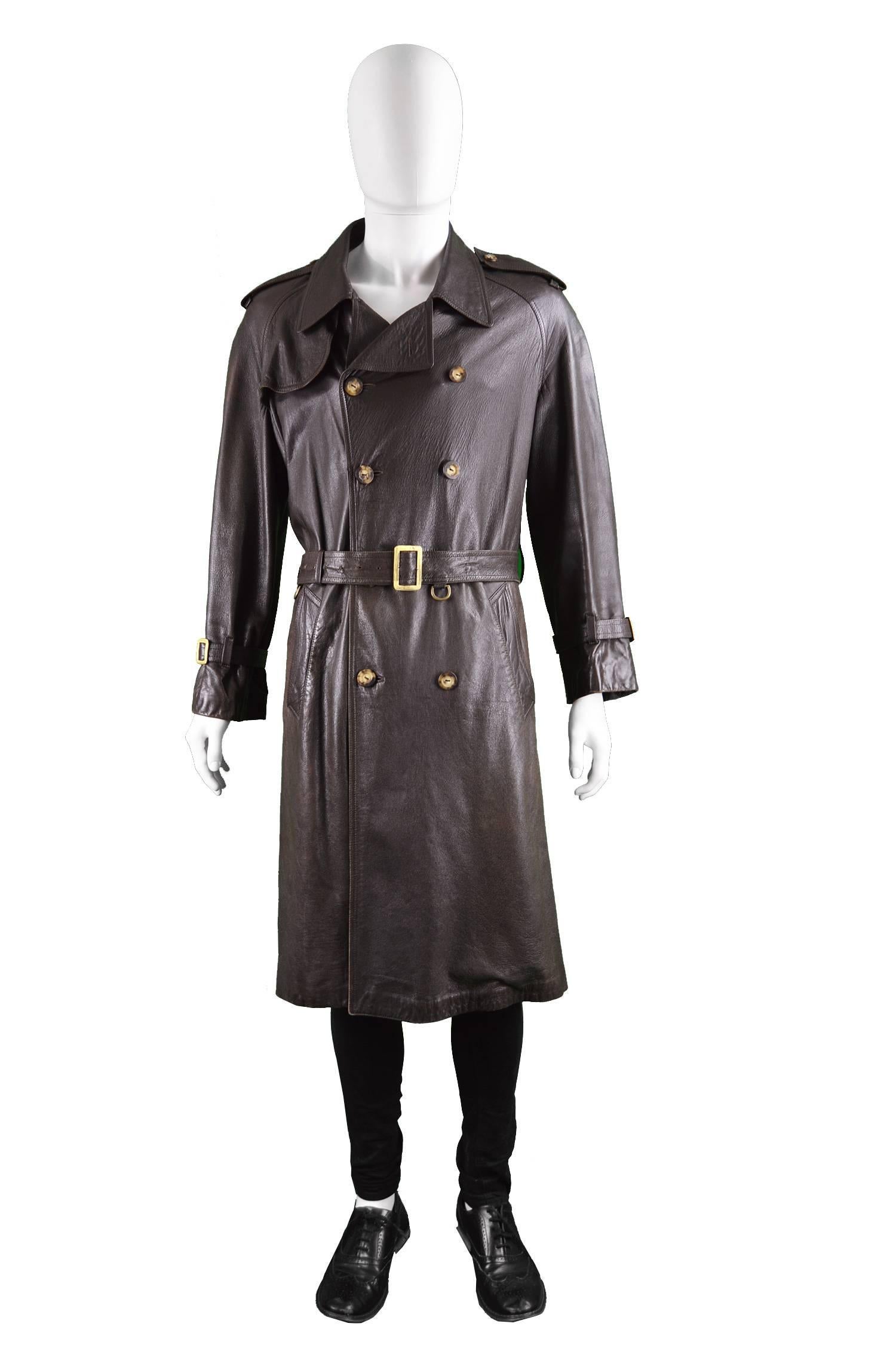 An incredible and rare vintage men's leather trenchcoat from the 60s by legendary British luxury label, Burberry, when prior to 1998, they were known as 'Burberrys'. In a high quality brown leather with double breasted buttons a belt to pull in the