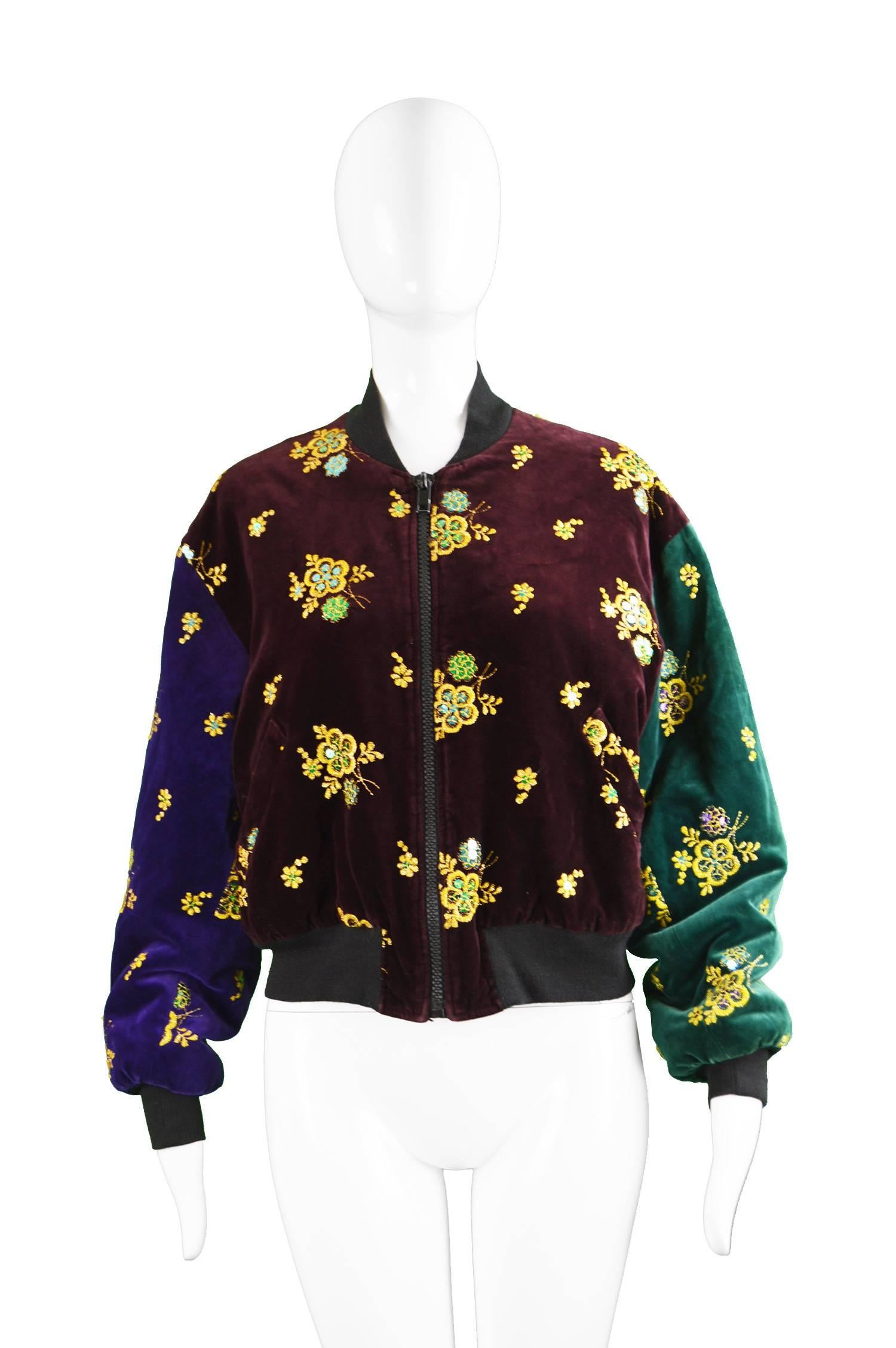 A beautiful womens vintage bomber jacket from the 90s by luxury Italian designer, Rifat Ozbek. Made in Italy, this high quality jacket has gold lamé embroidery and sequins throughout luxurious velvet in blocks of green, burgundy and purple. 

Size: