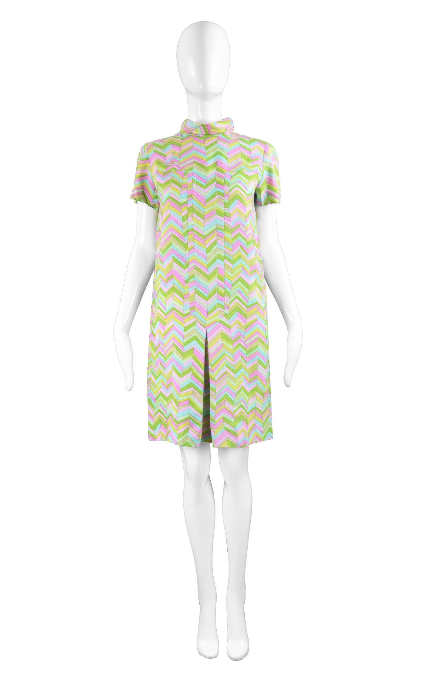 A fine and rare vintage shift dress from c. the mid 60s by Pierre Cardin under the rare 'Jeunesse' line for luxury Japanese department store, Takashimaya. In a colourful, pink blue and green lightweight linen with zig zags throughout. With a high