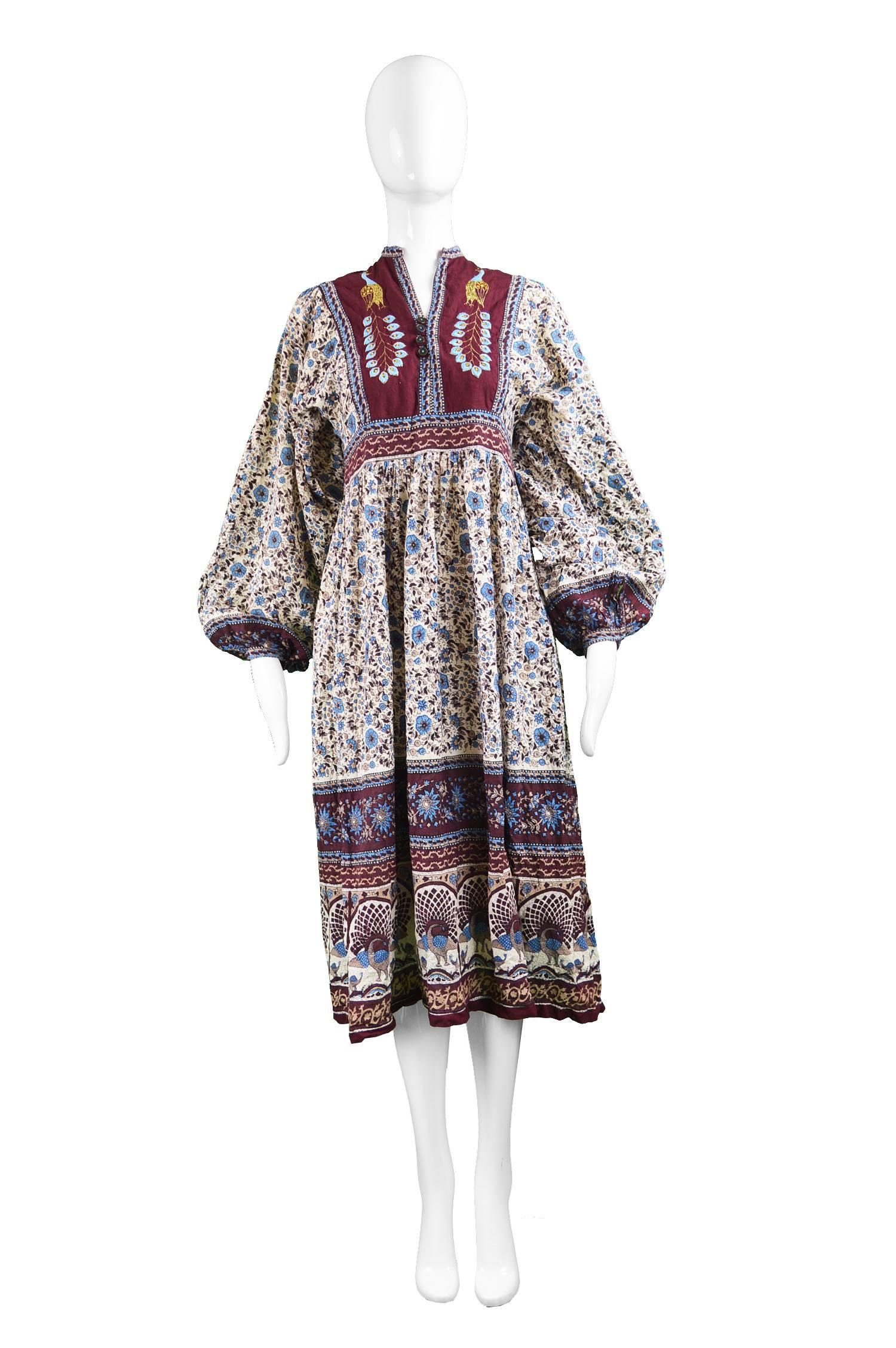 A stunning vintage and highly collectable vintage Indian dress from the 70s in a fine cotton gauze which is so floaty has a just the right amount of sheerness when the sun hits the skirt, giving a diaphanous, flowy quality. The floral block print is