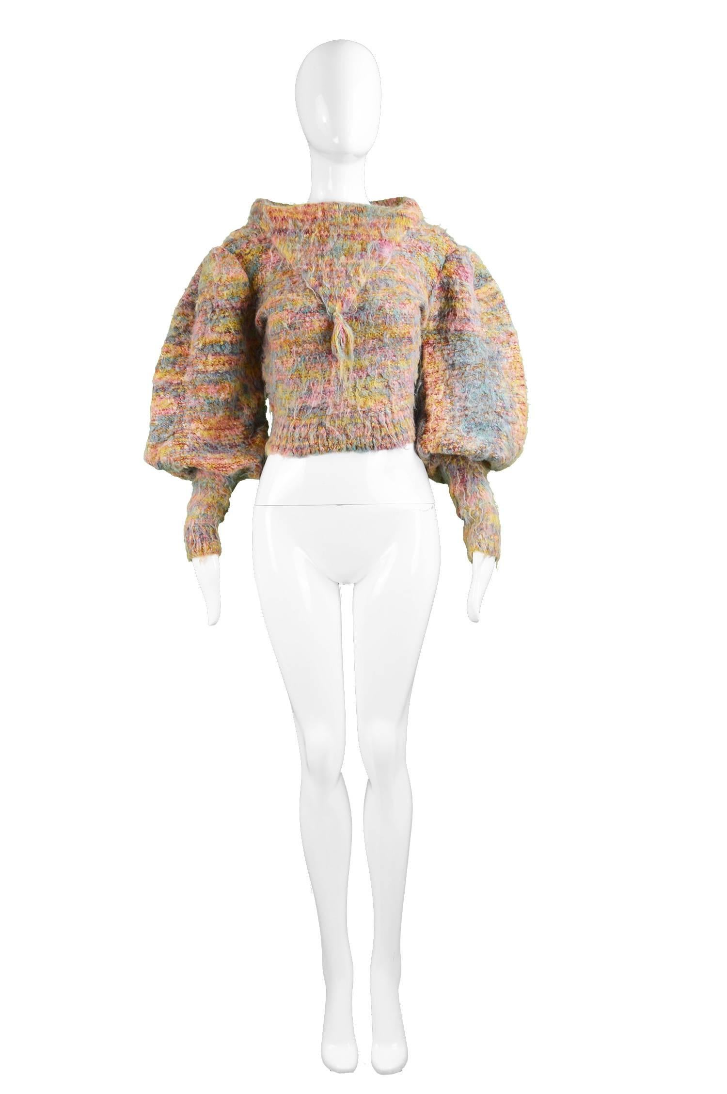 A dramatic and avant garde vintage women's sweater from the 1980s by highly collectable luxury knitwear designer, Gil Aimbez for Static. In a multicoloured fuzzy rainbow knit fabric with huge leg o mutton / balloon sleeves that flare out at the