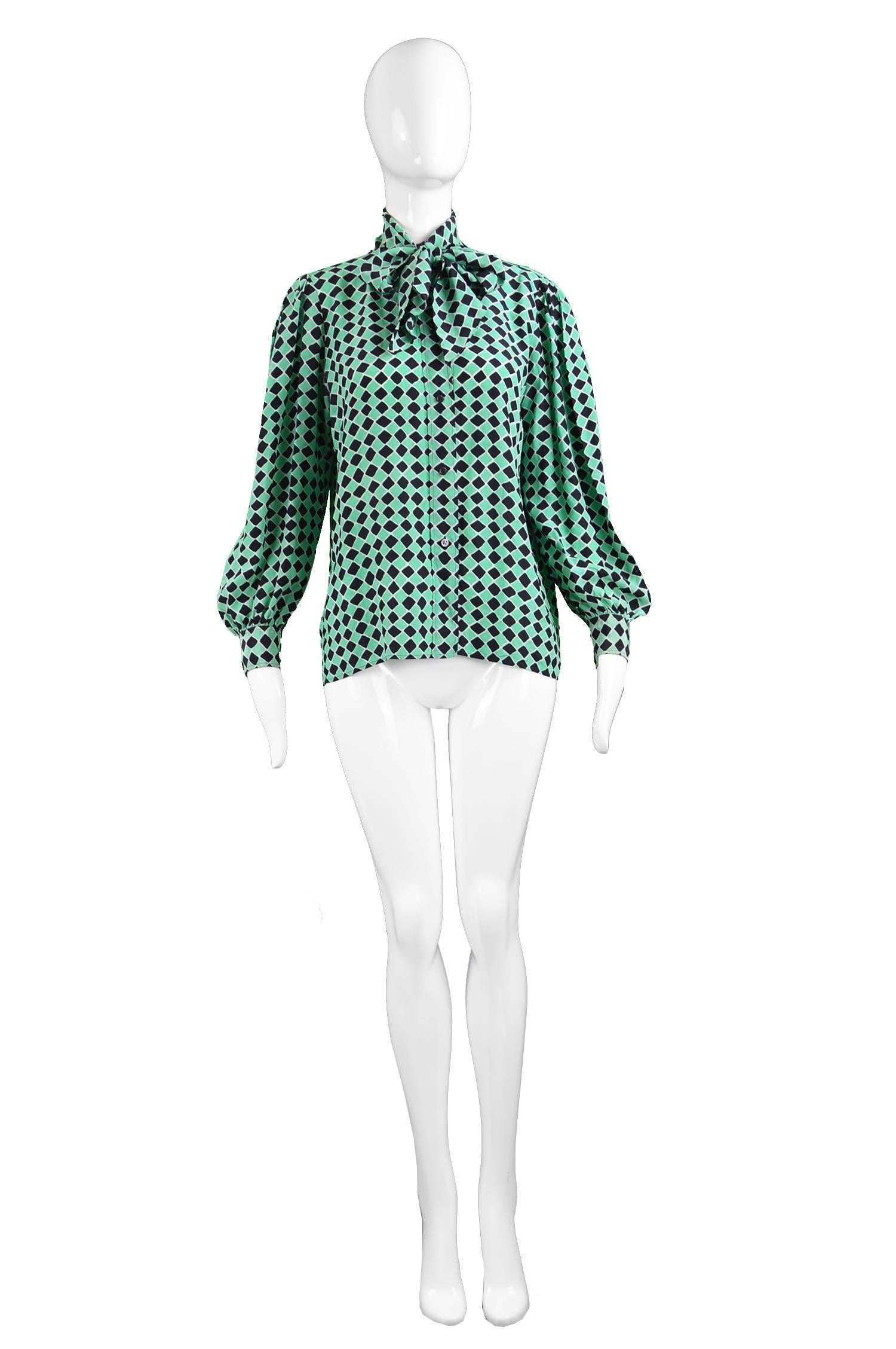 A chic vintage ladies YSL shirt from the 70s by Yves Saint Laurent for his highly collectable rive gauche line. In a green and black diamond printed silk with a pretty pussybow detail at the neck and balloon sleeves. Perfect as an office career