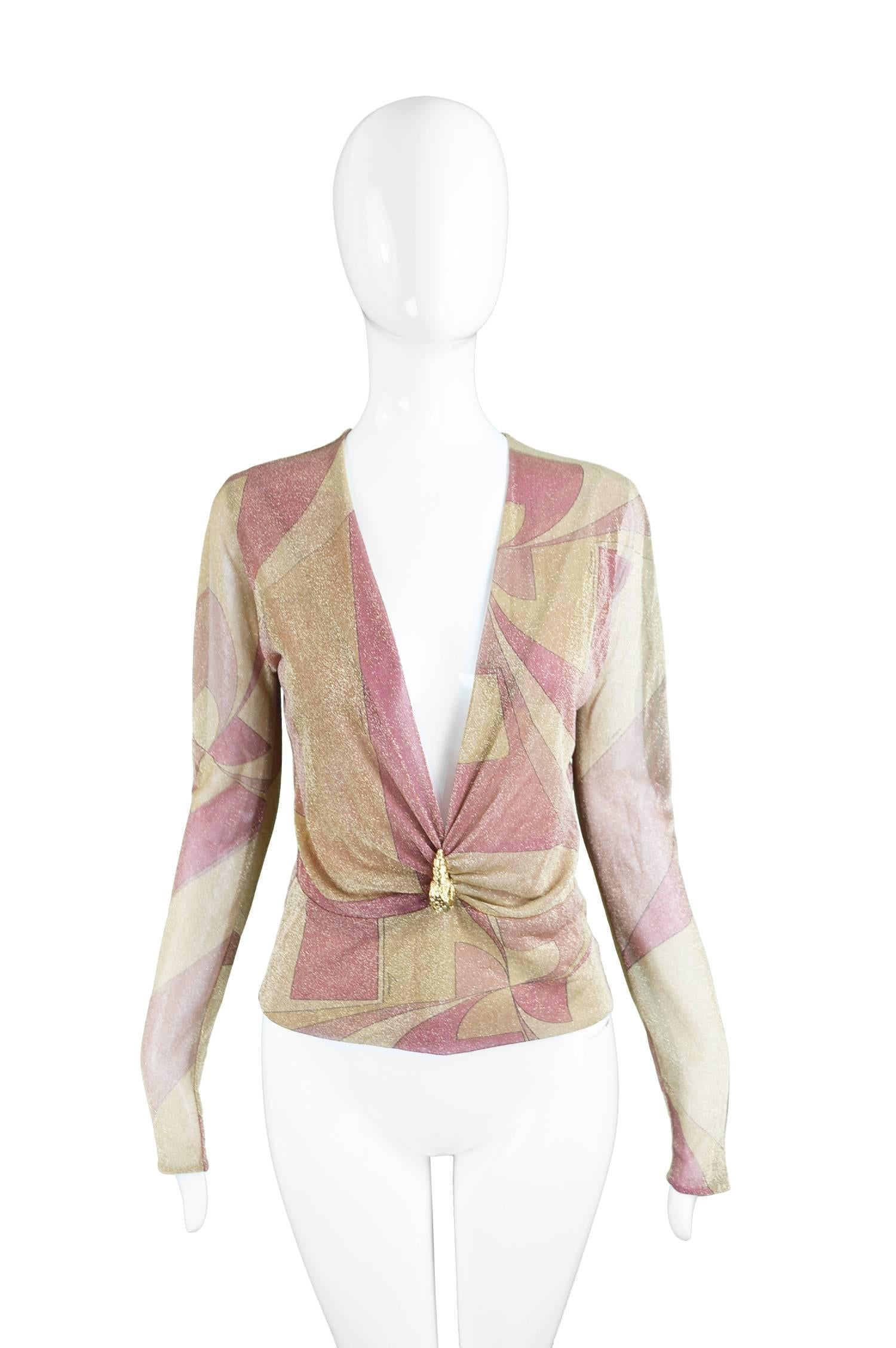 A stunning blouse by Gucci designed by Tom Ford for the Fall 2000 collection. In a lightweight silk, shot with a sparkly, metallic gold lurex that is dual layered on the body and single layered on the sleeves to give a sheer quality. 

The print is