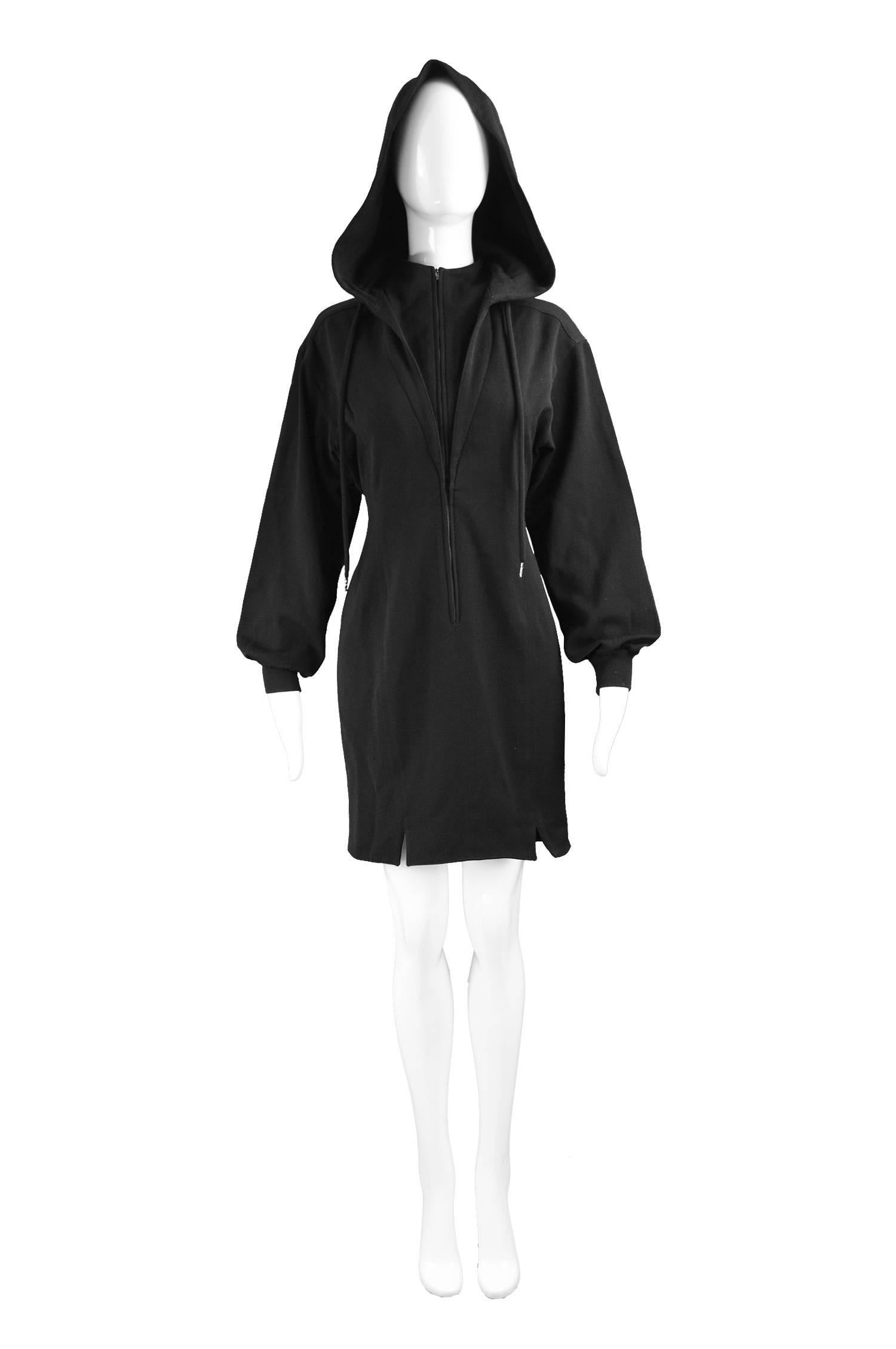Claude Montana Vintage Black Hooded Wool Mini Dress, 1980s

Estimated Modern Size: UK 12/ US 8/ EU 40. Please check measurements. 
Bust - 36” / 91cm
Waist - 30” / 76cm
Hips - 38” / 96cm
Length (Shoulder to Hem) - 33” / 84cm
Shoulder to Shoulder -