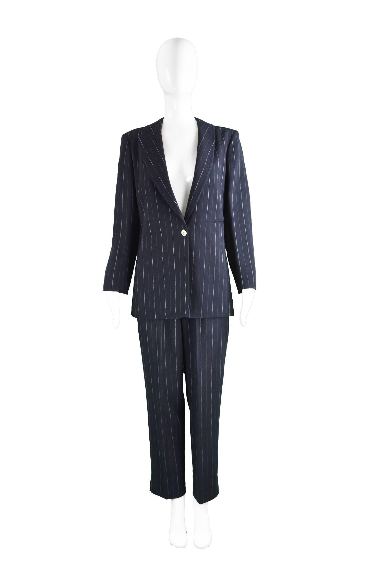 Claude Montana Women's Vintage Navy Blue Wool Pinstripe 2 Piece Pant Suit, 1990s

Size: The jacket is marked an 42 and the trousers a 44 but the jacket has a looser, slightly oversized fit so would suit a larger size. Estimated to be a modern UK