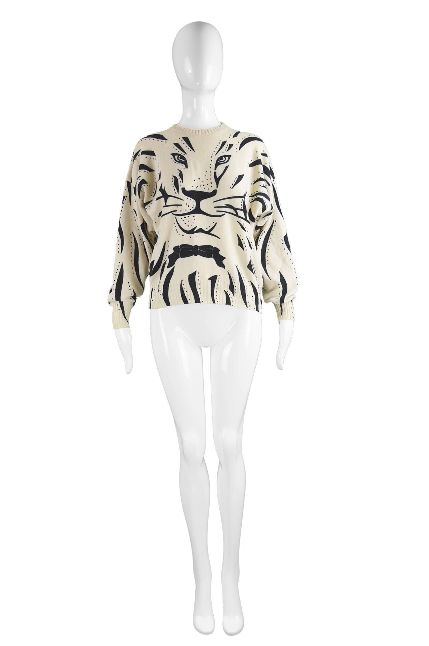 Krizia Iconic 'Animal Series' Cream Wool Tiger Face Sweater, 1980s

Estimated Size: Women's Small to Medium but this gives a slouchy, oversized fit.
Bust - up to 44” / 112cm
Length (Shoulder to Hem) - 22”  / 56cm
Note: Item has stretch so there is