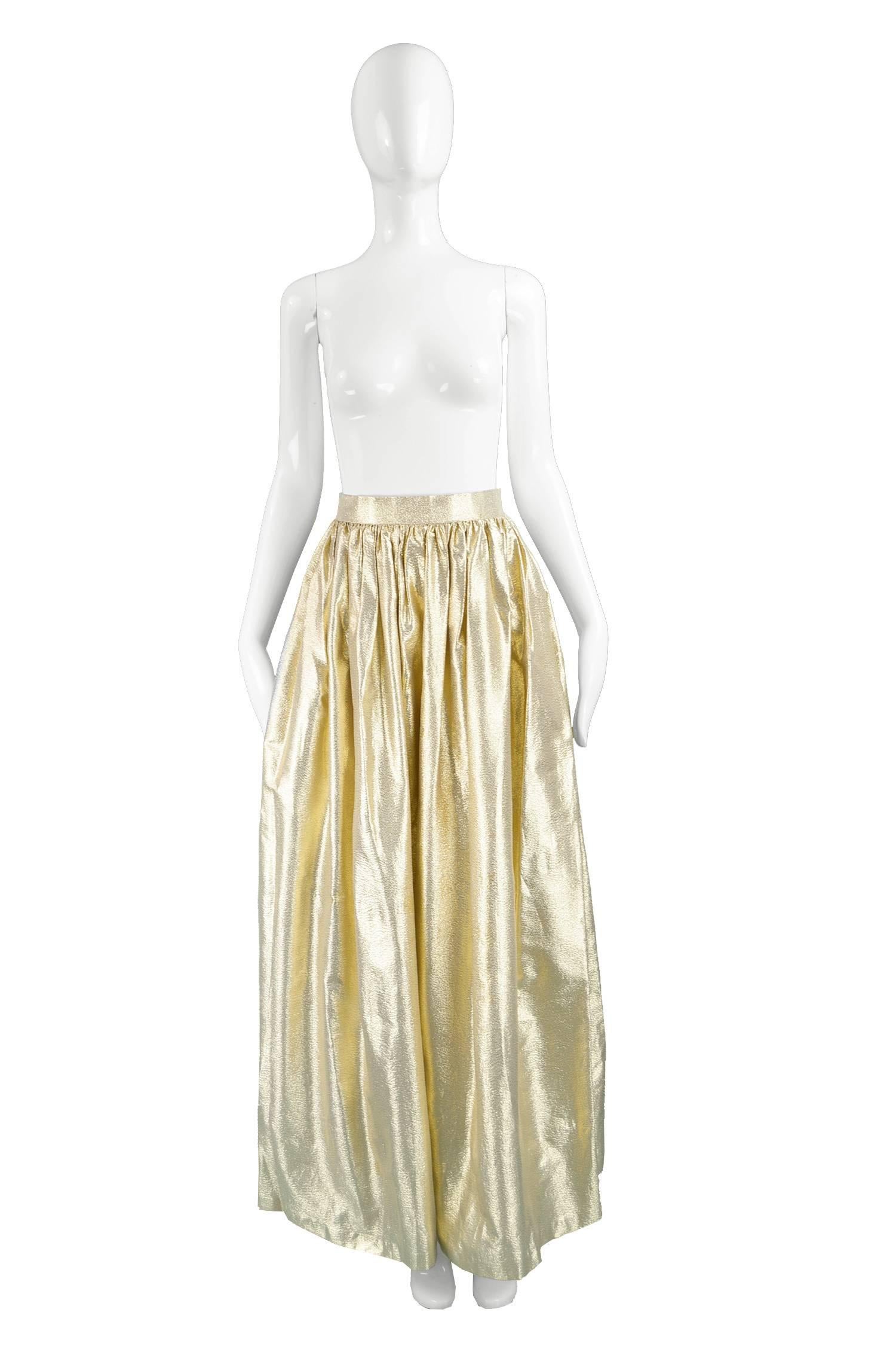 Albert Capraro Vintage Metallic Gold Lamé Maxi Skirt, 1980s

Estimated Size: UK 8/ US 4/ EU 36. Please check measurements. 
Waist - 26” / 66cm
Hips - Free
Length (Waist to Hem) - 42” / 106cm
 
Condition: Excellent Vintage Condition - Couple of very