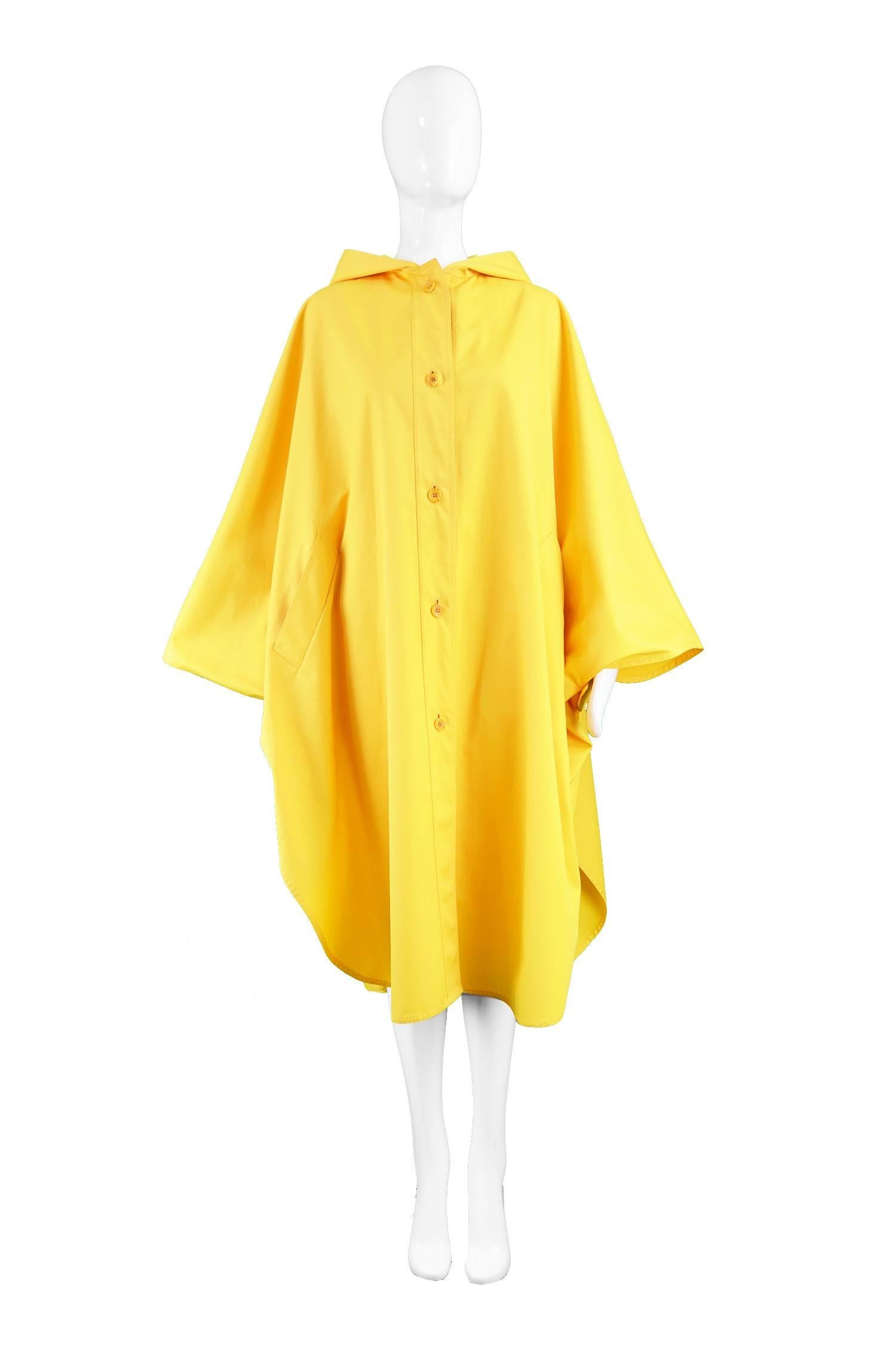 Aquascutum Vintage Mustard Yellow Hooded Trench Poncho Cloak Coat, 1980s 

Size: One size fits most. 
Bust - Free
Waist - Free
Length (Shoulder to Hem) - 44” / 112cm

Condition: Excellent Vintage Condition - A few very small, very faint marks as