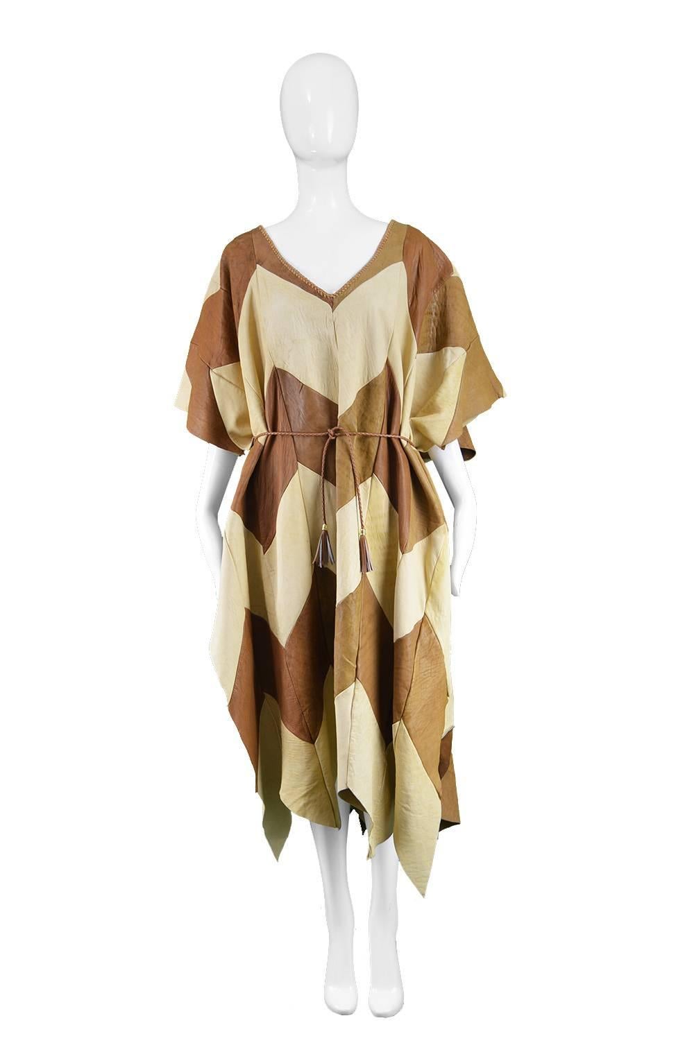 Vintage Cream & Brown Leather Patchwork Maxi Mexican Poncho Cape, 1970s

Size: One size fits all. Slips on over the head and is open at the sides. Belt fits Small to Large.
Bust - Free
Waist - Free
Hips - Free
Length (Shoulder to Hem) - 49” /