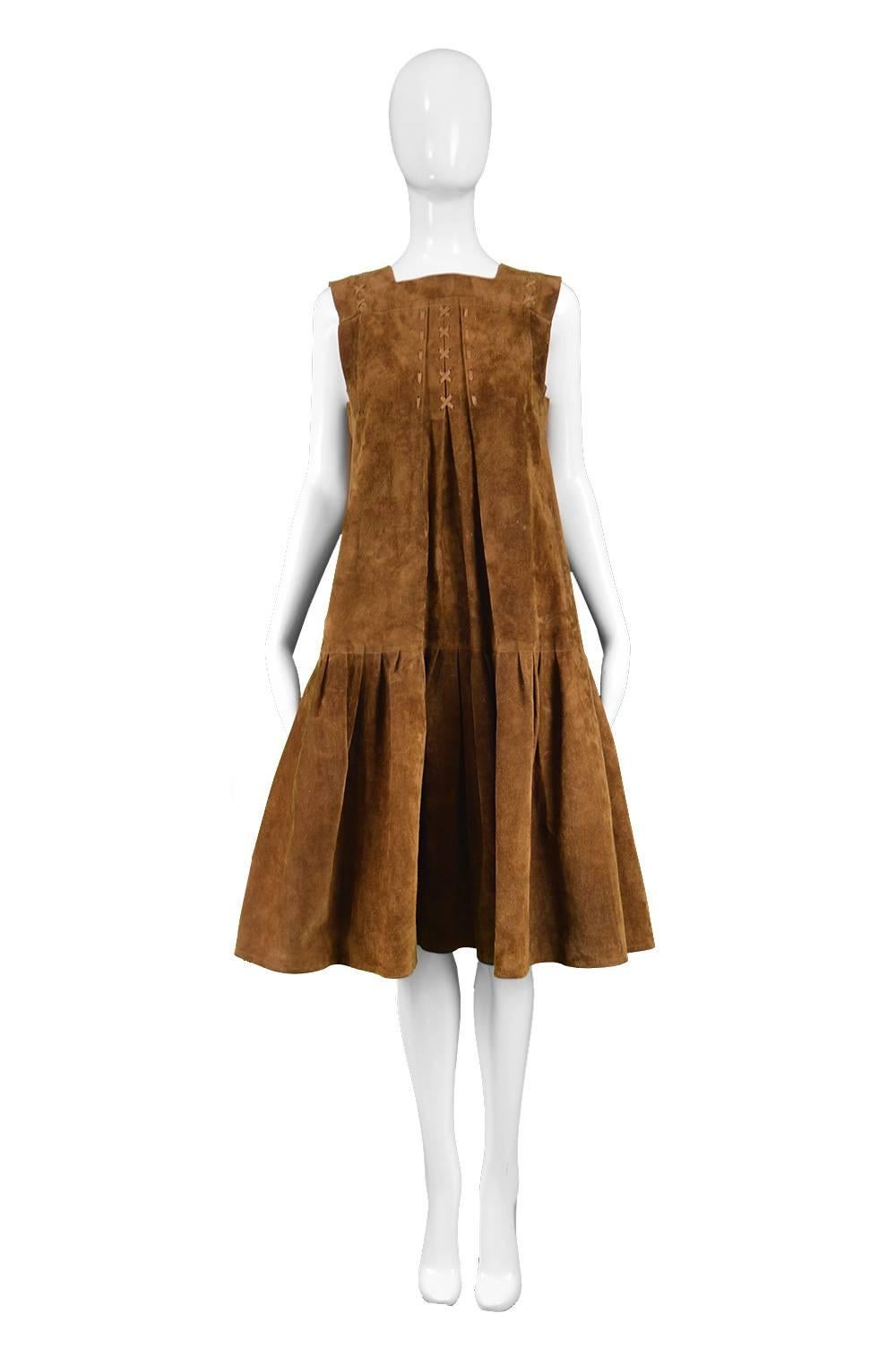 Jean Muir Brown Suede Vintage Sleeveless Pinafore Dress / Jacket, 1970s

Estimated Size: UK 10/ US 6/ EU 38 but would also suit a taller UK 8/ US 4 with a slightly looser fit. Please check measurements. 
Bust - 36” / 91cm (allow a couple of inches