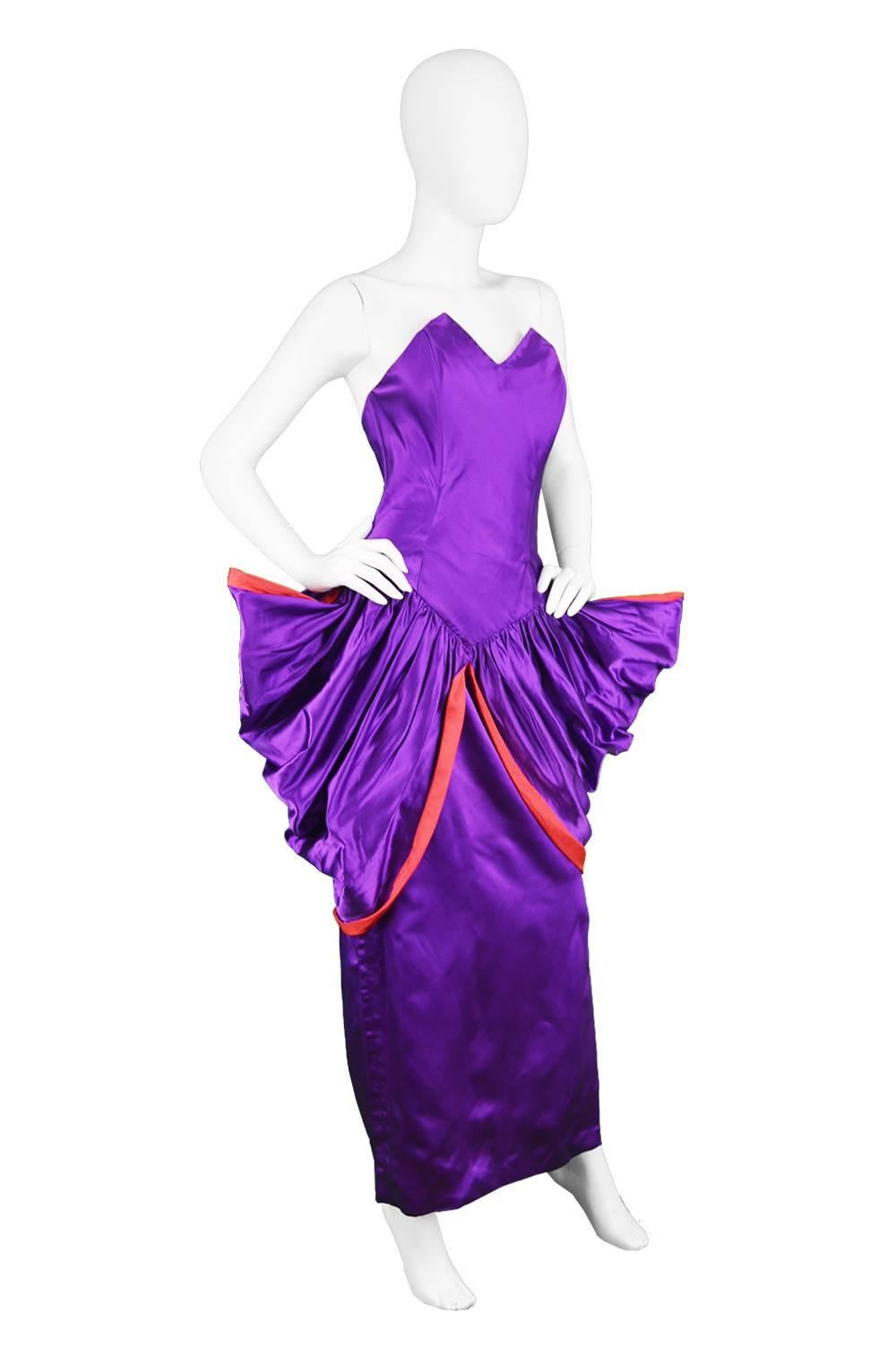 Yuki Architectural Purple & Red Silk Satin Couture Evening Dress, 1980s

Estimated Size: UK 8/ US 4/ EU 36. Please check measurements. 
Bust - Approx 32” / 81cm, hard to measure due to strapless, low back design but fits our 32” bust mannequin
Waist