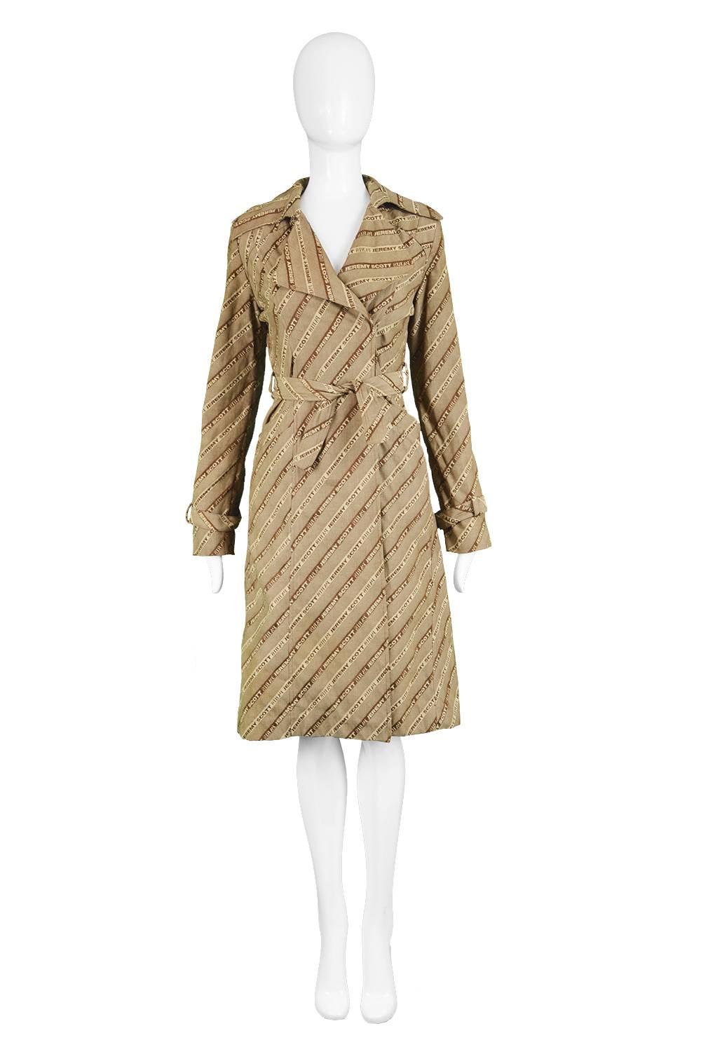Iconic Jeremy Scott Logomania 'Duty Free Glamour' Trench Coat, S/S 2000

Estimated Size: UK 10/ US 6/ EU 36. Please check measurements. 
Bust - 36” / 91cm (allow a couple of inches room for movement)
Waist - 30” / 76cm
Hips - 40” / 101cm
Length