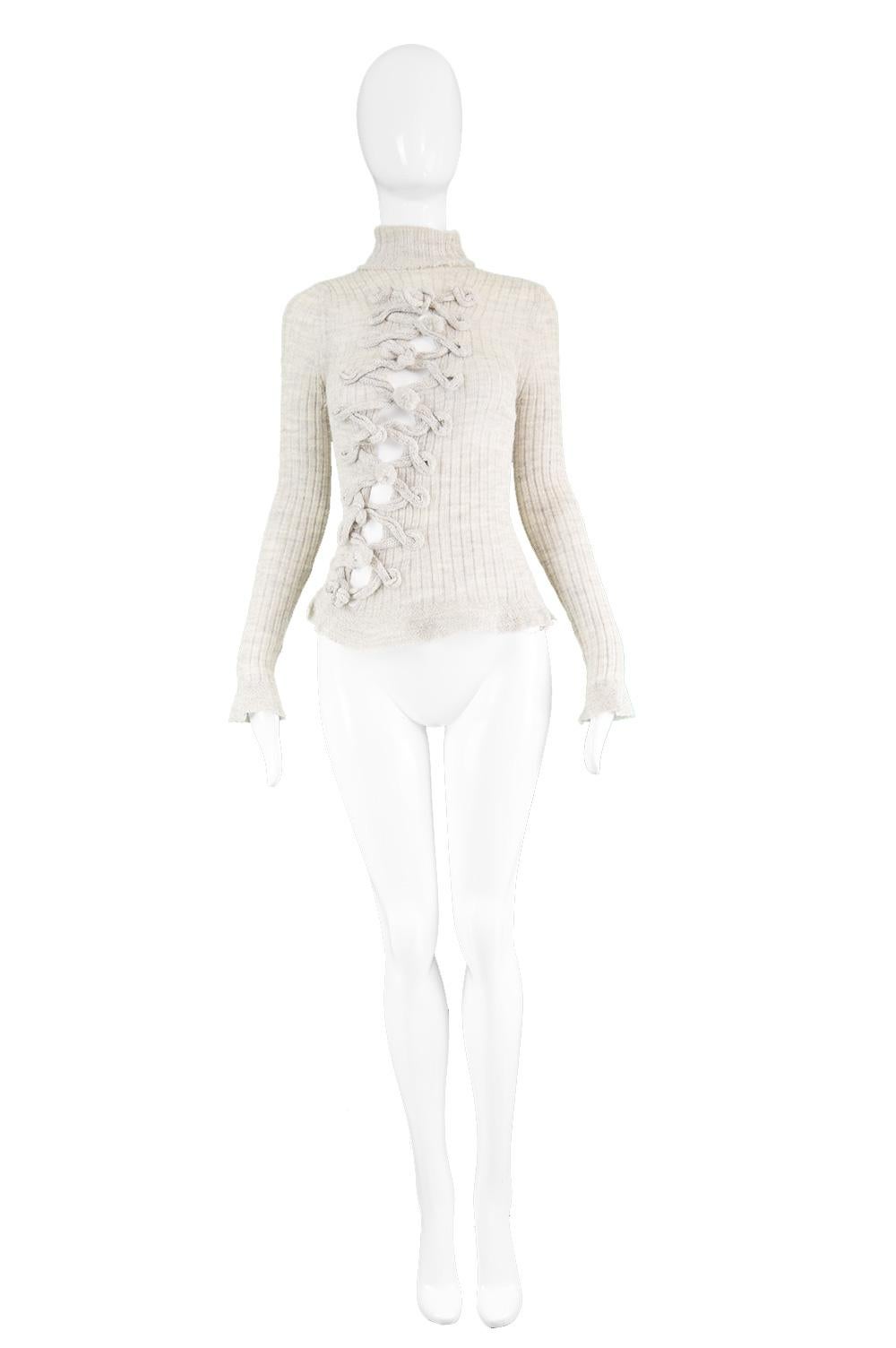 Jean Paul Gaultier Vintage Fine Knitted Turtleneck Cut Out Jumper, 1990s

Estimated Size: Women's Small. Please check measurements. 
Bust - Stretches Up to 34” / 86cm
Waist - Up to 30” / 76cm
Length (Shoulder to Hem) - 22” / 56cm
Sleeve Pit to Cuff
