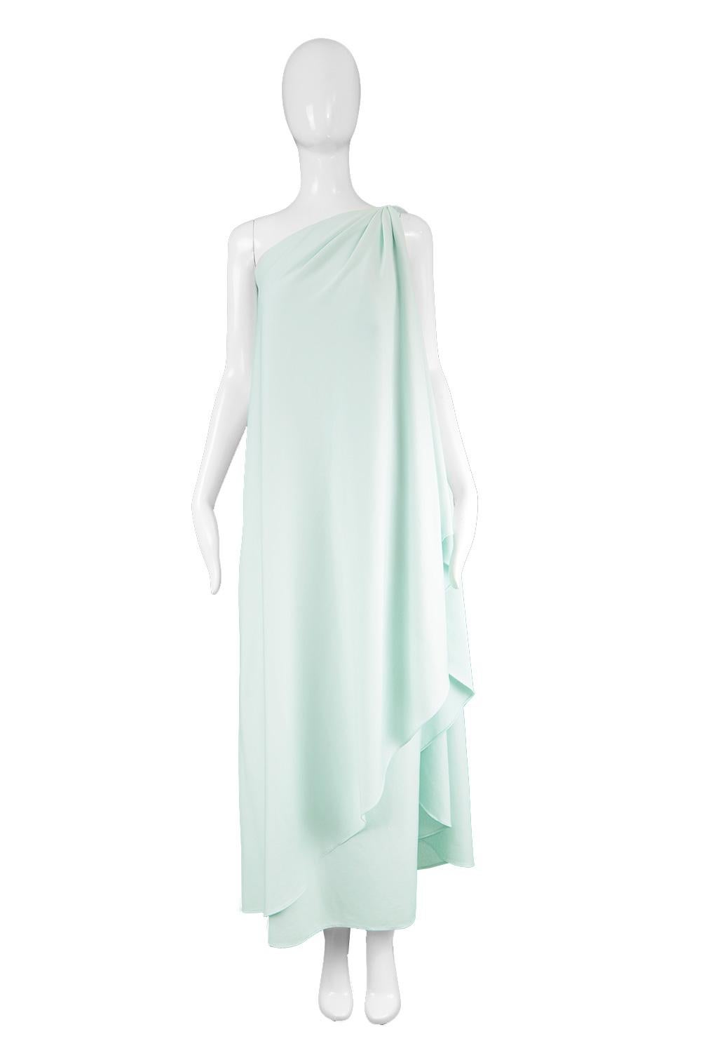 Halston Vintage Mint Green Draped Grecian One Shouldered Jersey Dress, 1970s

Size: Marked M would also suit a Small due to flowy, draped fit. 
Bust - Up to 38” / 96cm
Waist - Up to 38” / 96cm
Hips - Up to 42” / 106cm
Length (Shoulder to Hem) - 52” 