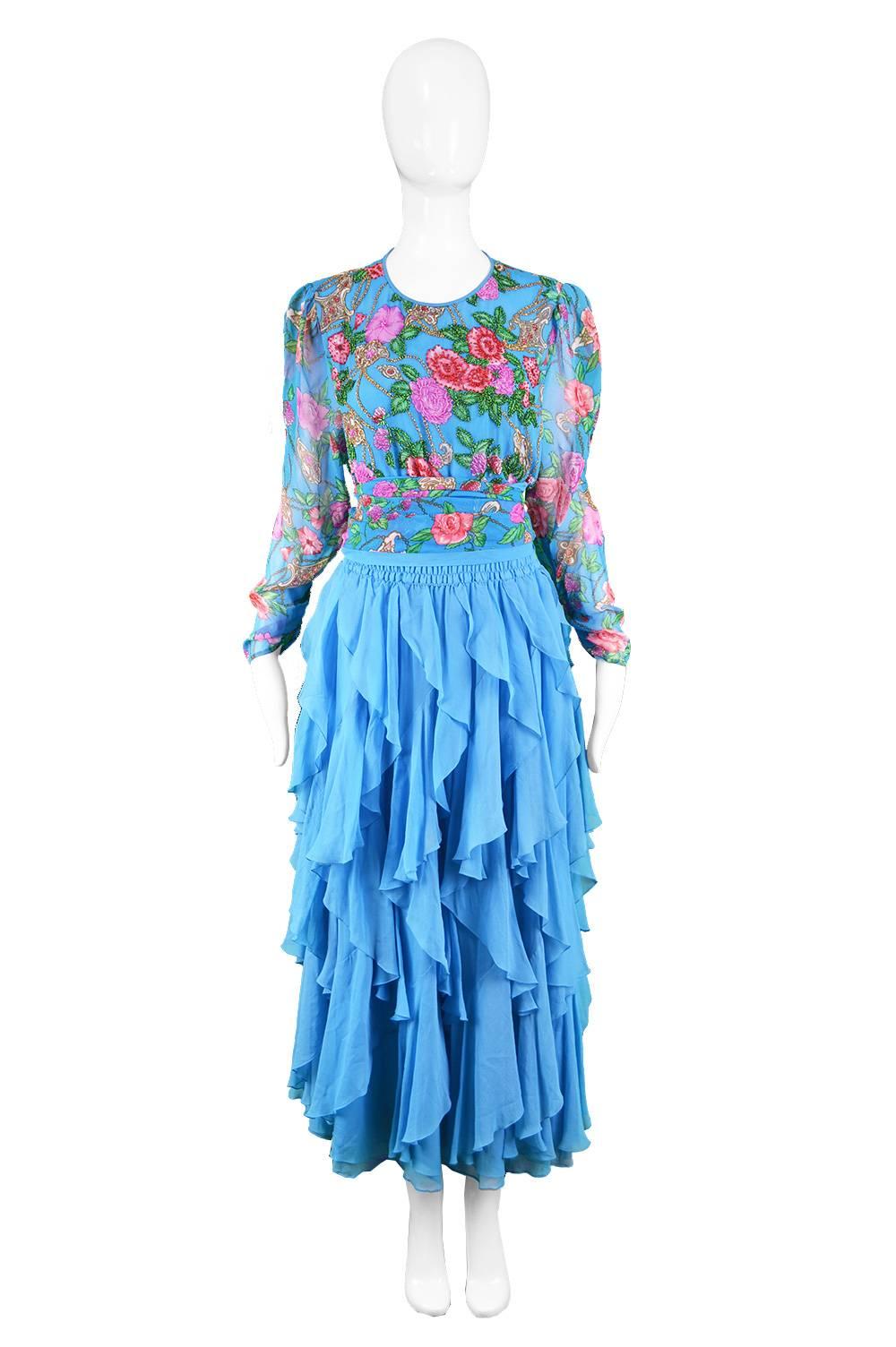 Diane Freis Vintage 1980's Beaded Blue Ruffle Silk Floral Georgette Dress

Estimated Size: UK 12-14/ US 8-10 / EU 40-42. Please check measurements. 
Bust - 40” / 101cm (meant to have a loose, blouson fit around bust)
Waist - stretches up to 34” /