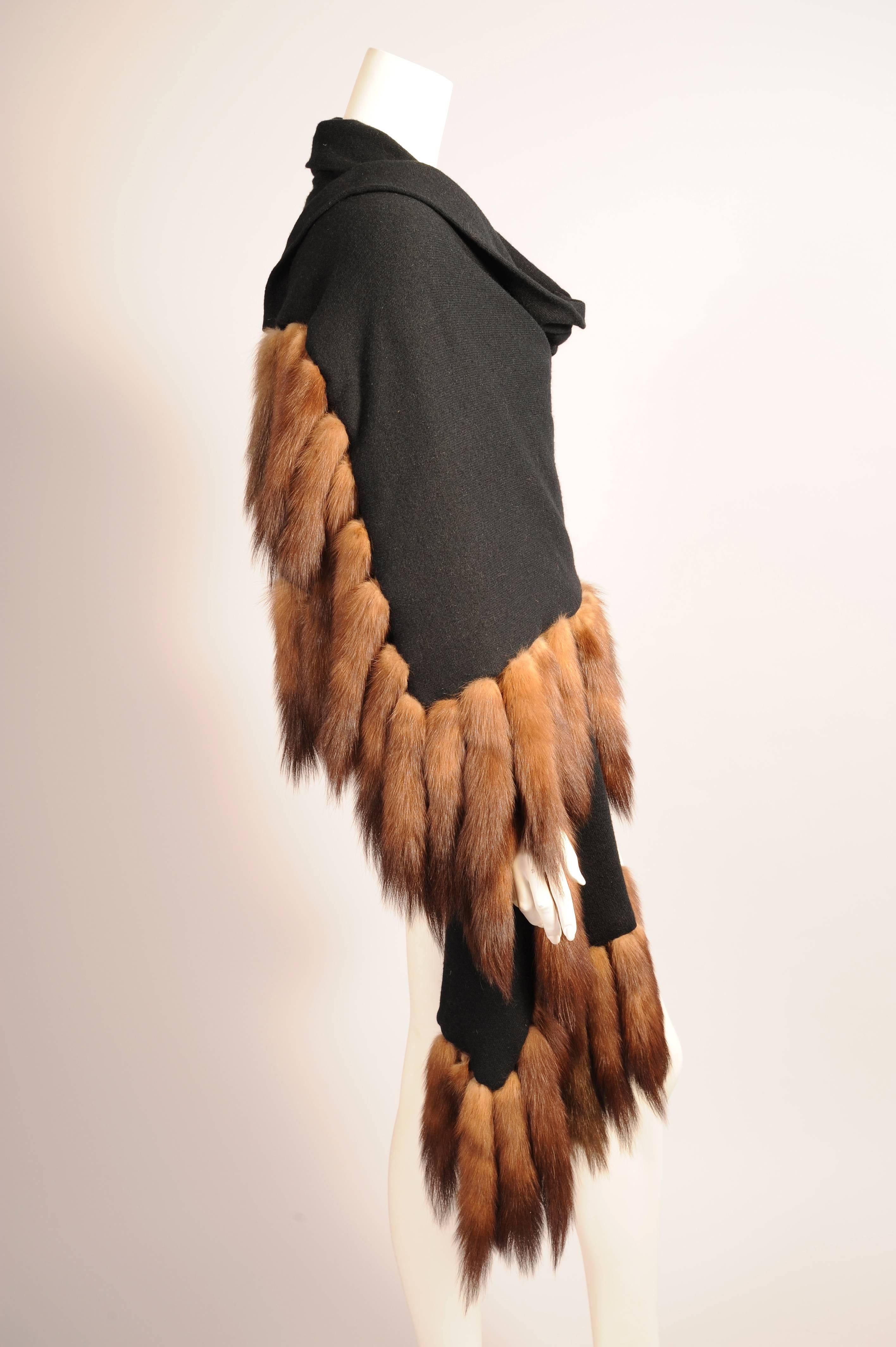 A luscious black cashmere shawl is trimmed with sable tails on three sides. The shawl is double thickness for added warmth. There is no label but it is  probably designed by Adrienne Landau. It is in excellent condition.
Measurements;
Length