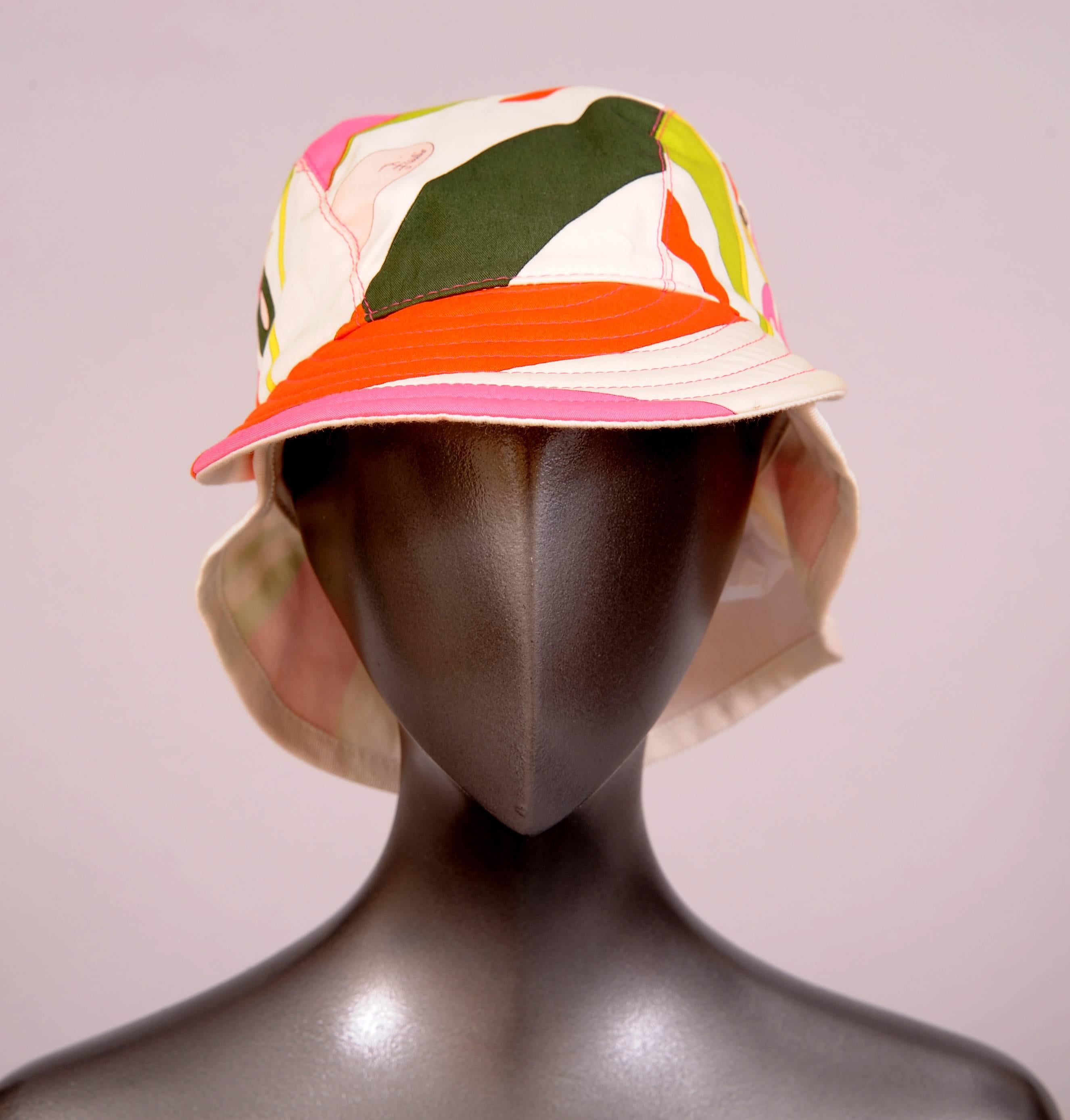 A bright and cheerful Pucci print on a white cotton background is used for this eye catching summer hat. The face shielding brim protecting you from the sun is channel quilted while the back panel keeps the sun off of your neck. It is in excellent