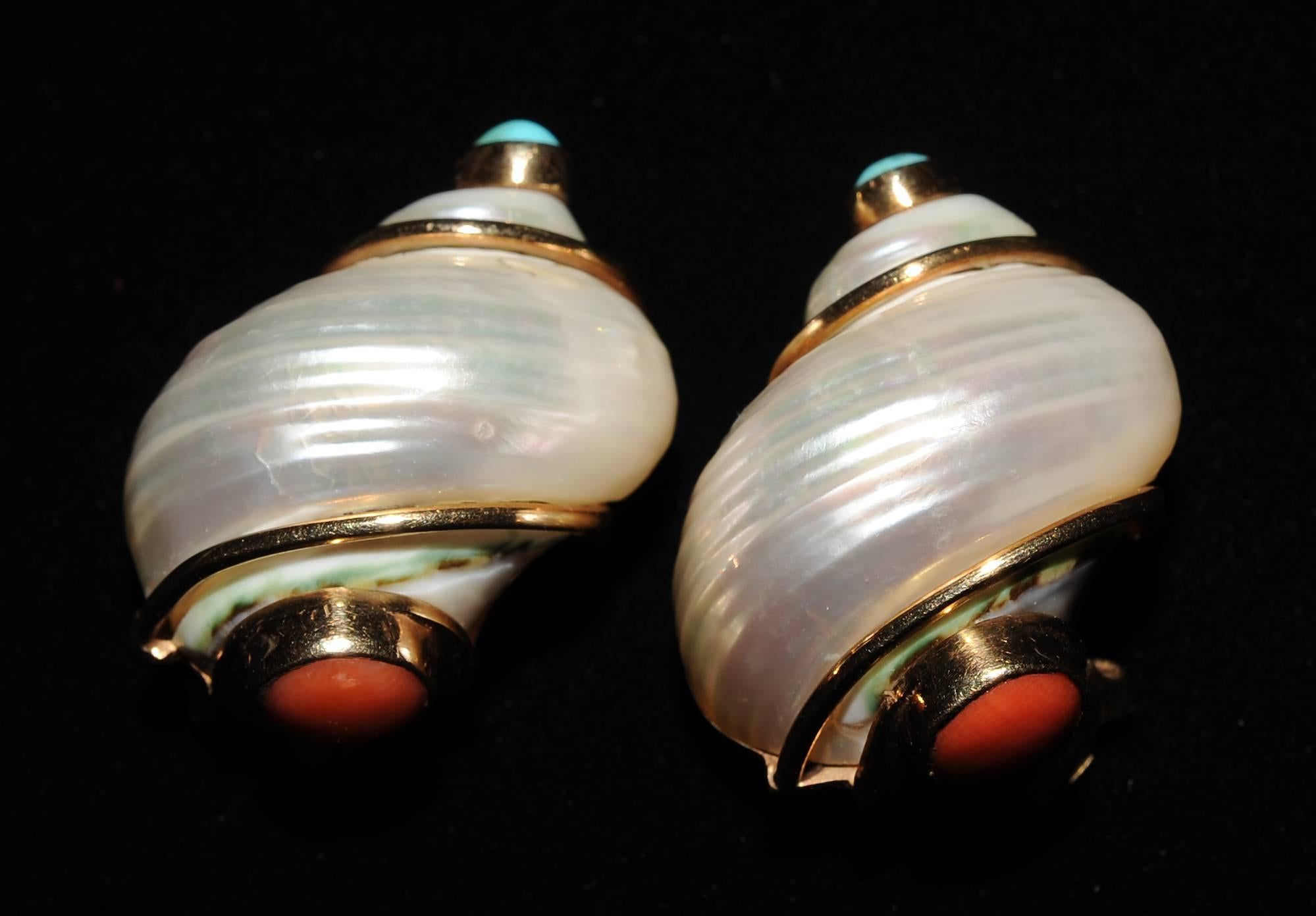 Classic Seaman Schepps turbo shell earrings are wrapped in gold and topped with bezel set turquoise stones. Adding interest the bottom of the earring is bezel set with coral. The earrings are stamped Seaman Schepps and 14K on the back. They are in