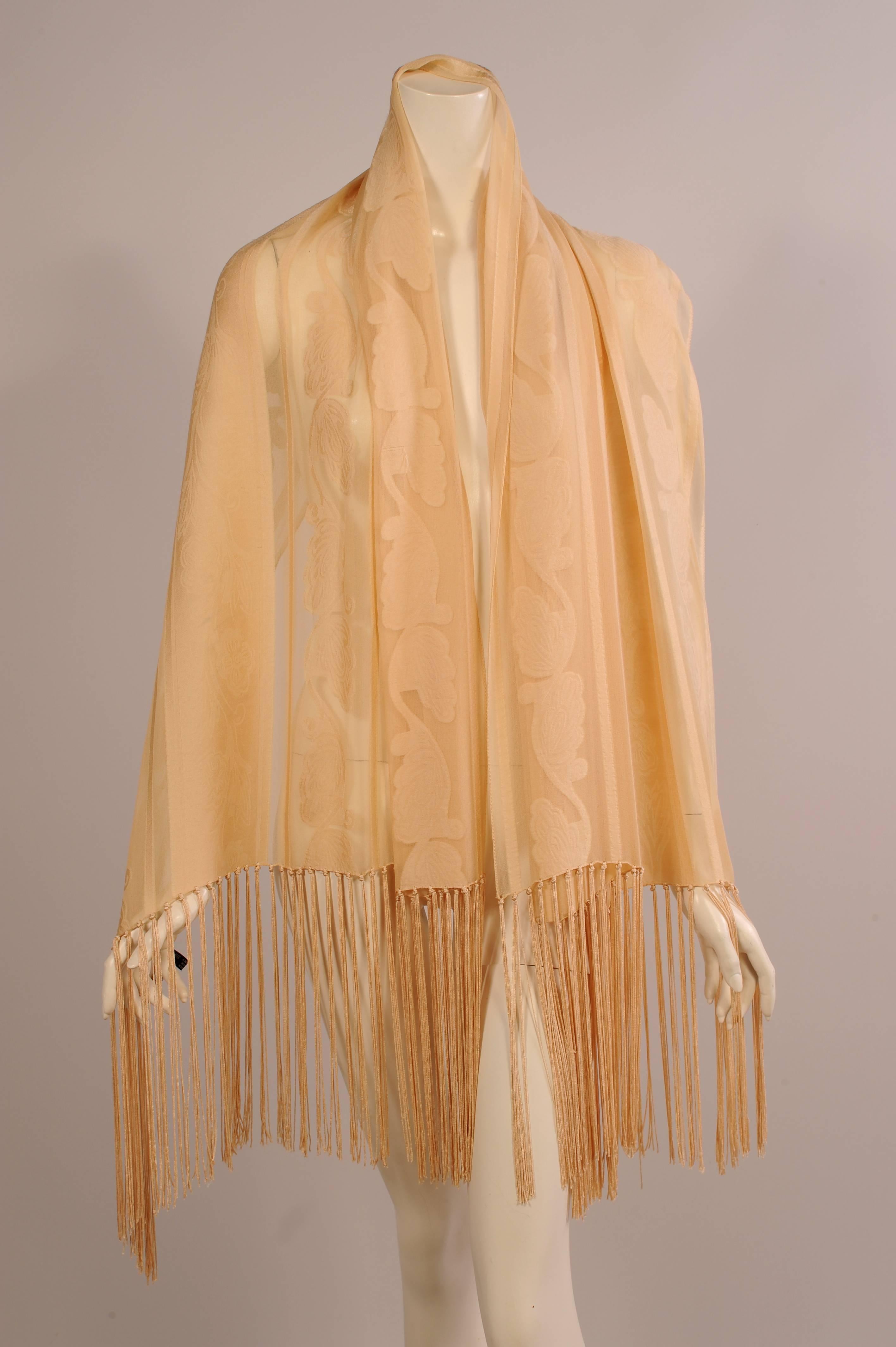 Beautifully woven sheer silk has narrow stripes and wide woven sylized vines, as well as wide wide woven bands with a floral vine. This elegant design is accented with ten inches of silk fringe at each end. This lovely shawl is in excellent