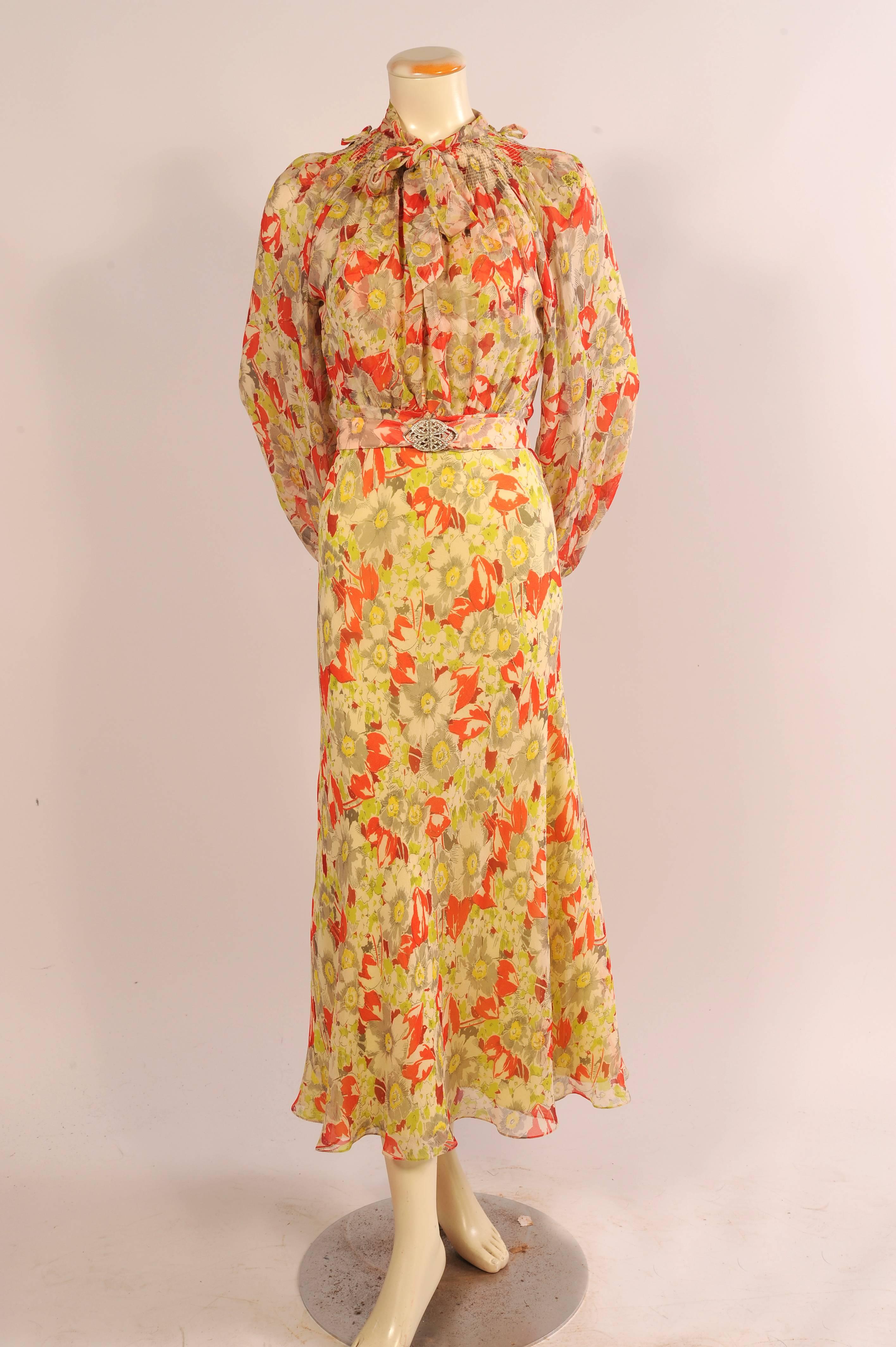 Everything about this dress and jacket says 1930's except for the fantastic quality of workmanship and the excellent condition of the outfit. Inspired by the 1930's this bias cut silk chiffon dress has a round neckline, cap sleeves, a raised Empire
