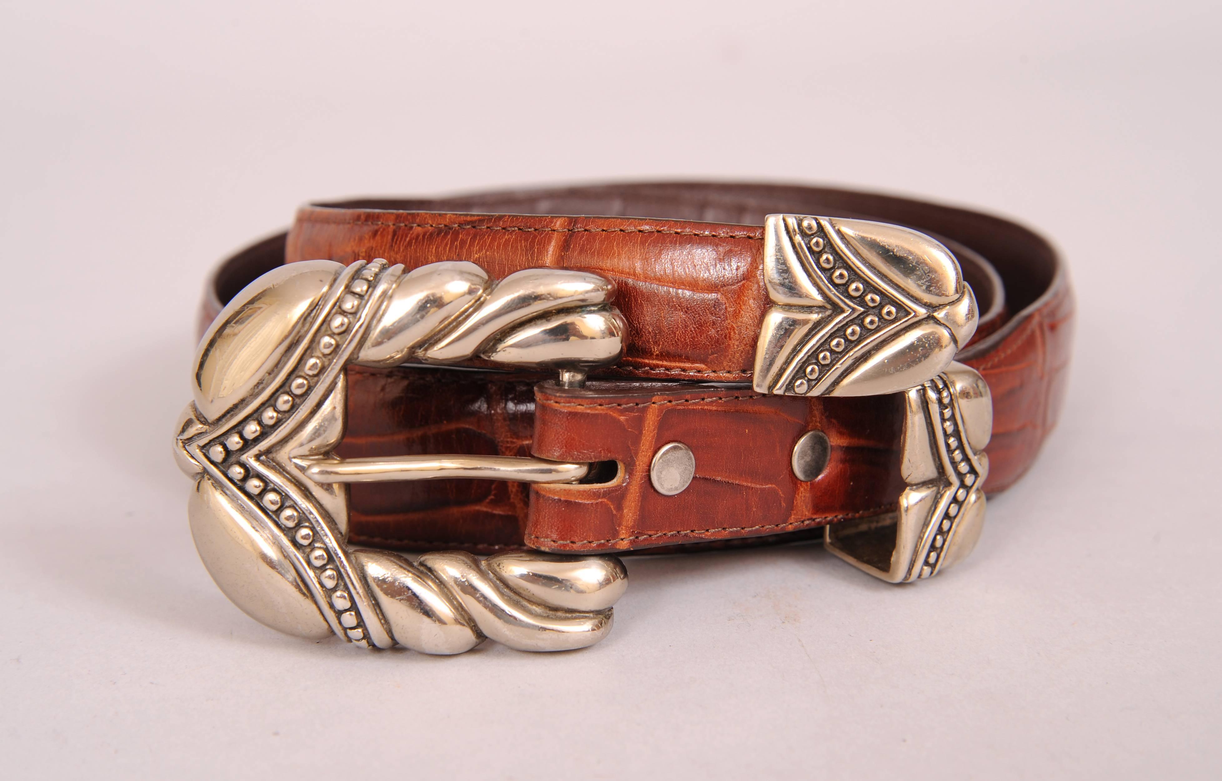 This great sporty leather belt with an alligator pattern has a sterling silver buckle, keeper and tip in a bold and graphic design. The belt is marked 32 and it is in excellent condition. It fits a size 30