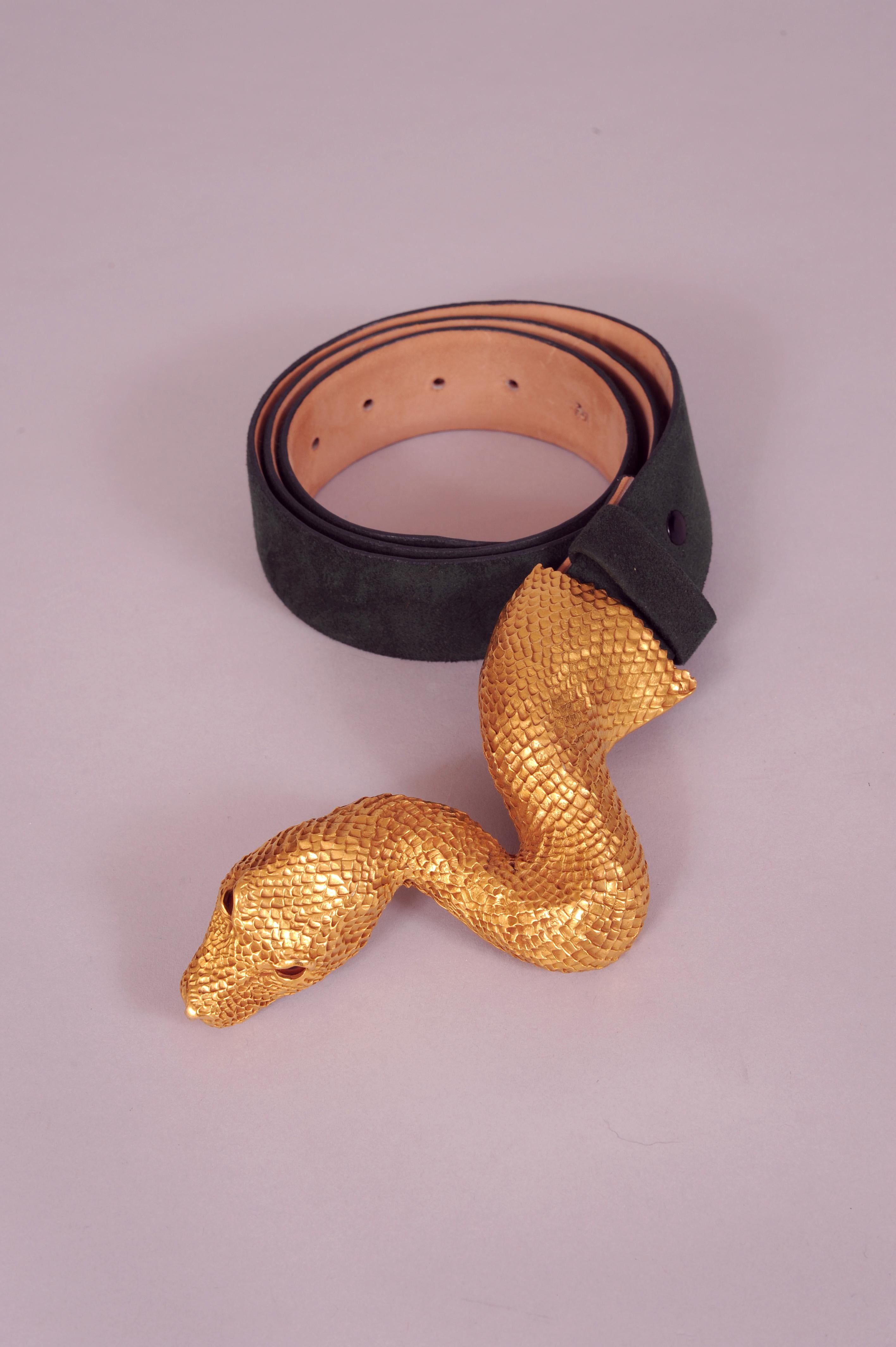 Christopher Ross is famous for his sculptural animal head belt buckles. This buckle is 24 karat gold plated with amber glass cabochon eyes. It is signed on the back and dated 1980. It is in excellent condition and shows no signs of wear. The Halston