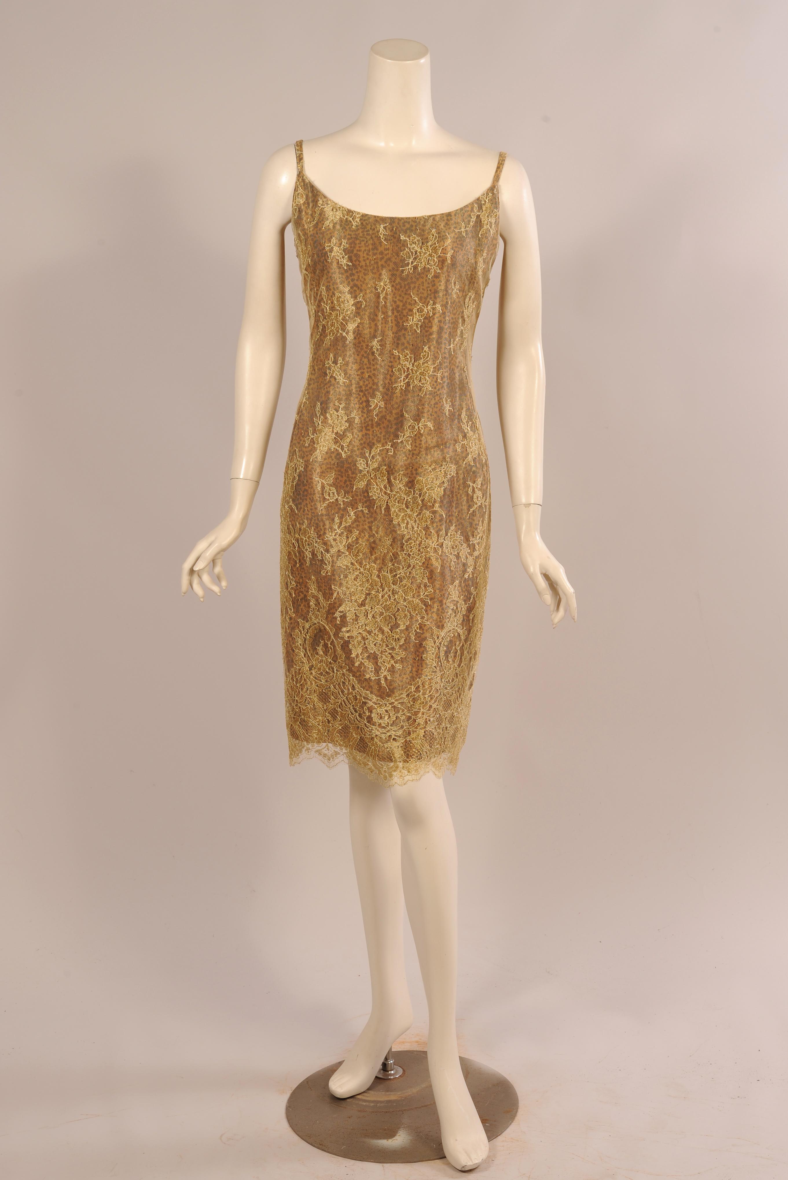 Lustrous gold lace is layered over a leopard print with a gold sheen for a subtle and unusual animal print dress. There are narrow straps, a center back invisible zipper and a scalloped hemline following the pattern of the lace.  The dress is lined