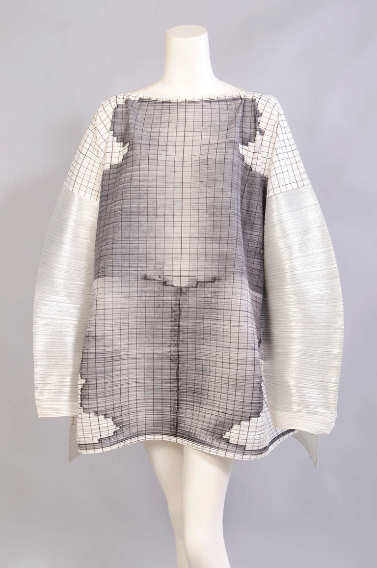 Issey Miyake and the Los Angeles based artist Tim Hawkinson collaborated on  the Guest Artist series  in 1998. These pieces are rare and collectible. LACMA has a similar piece in their collection. The image on the front of the tunic is silk screened