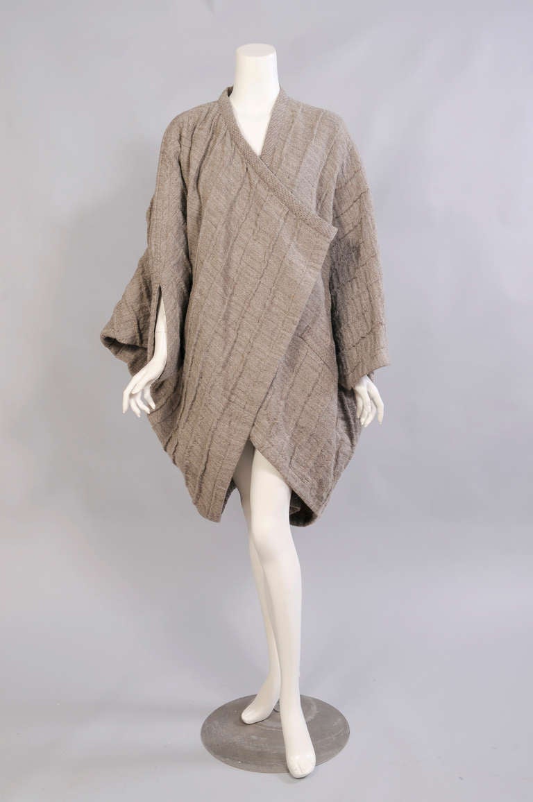 Made from a combination of wool and linen this early Miyake  cocoon coat is strikingly different from every angle. The coat has two pockets, no closure, and it was retailed by Bergdorf Goodman in the 1980's. It is marked a size small but it would