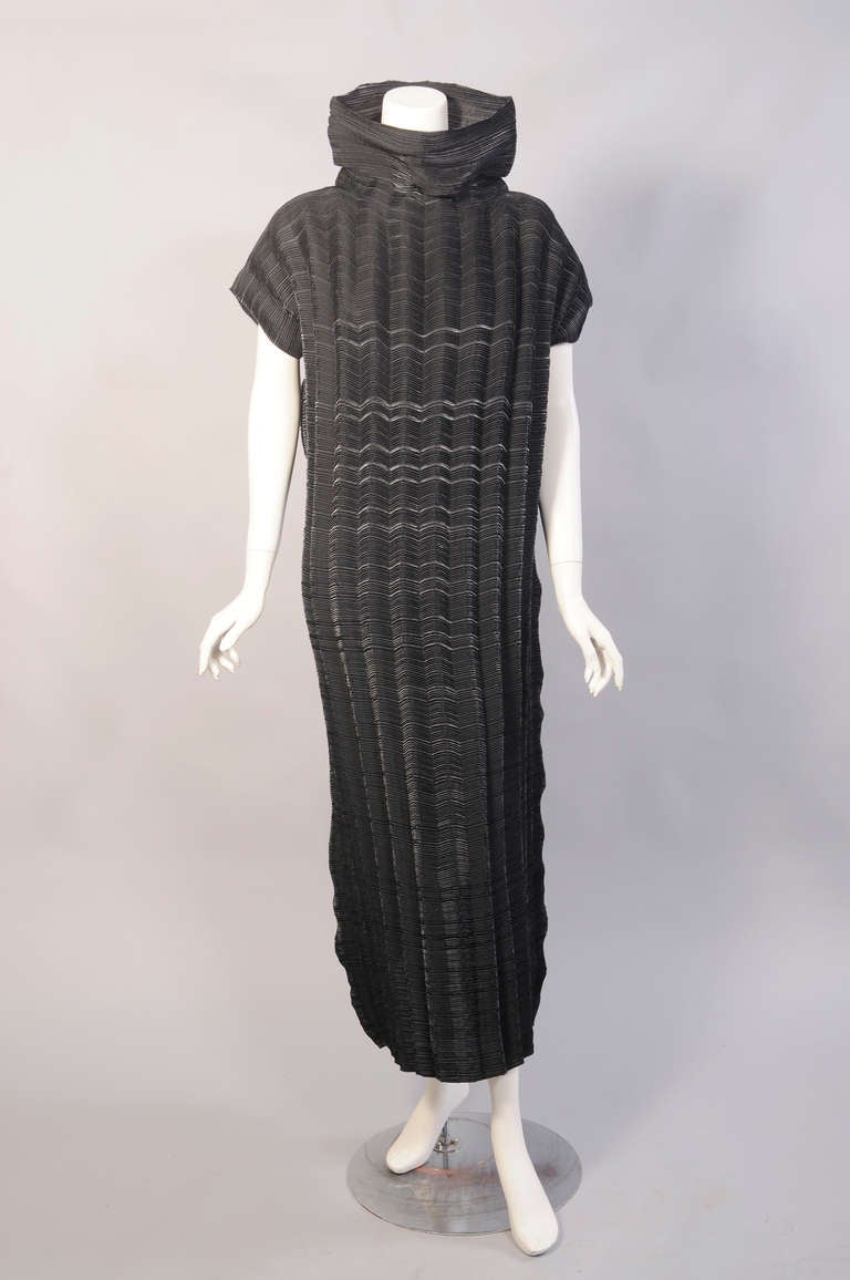 Issey Miyake designed this piece for Autumn/Winter 93-94 collection. It is a sleeveless black Wave pleats dress with a funnel neckline. It is in excellent condition and marked a size Small.