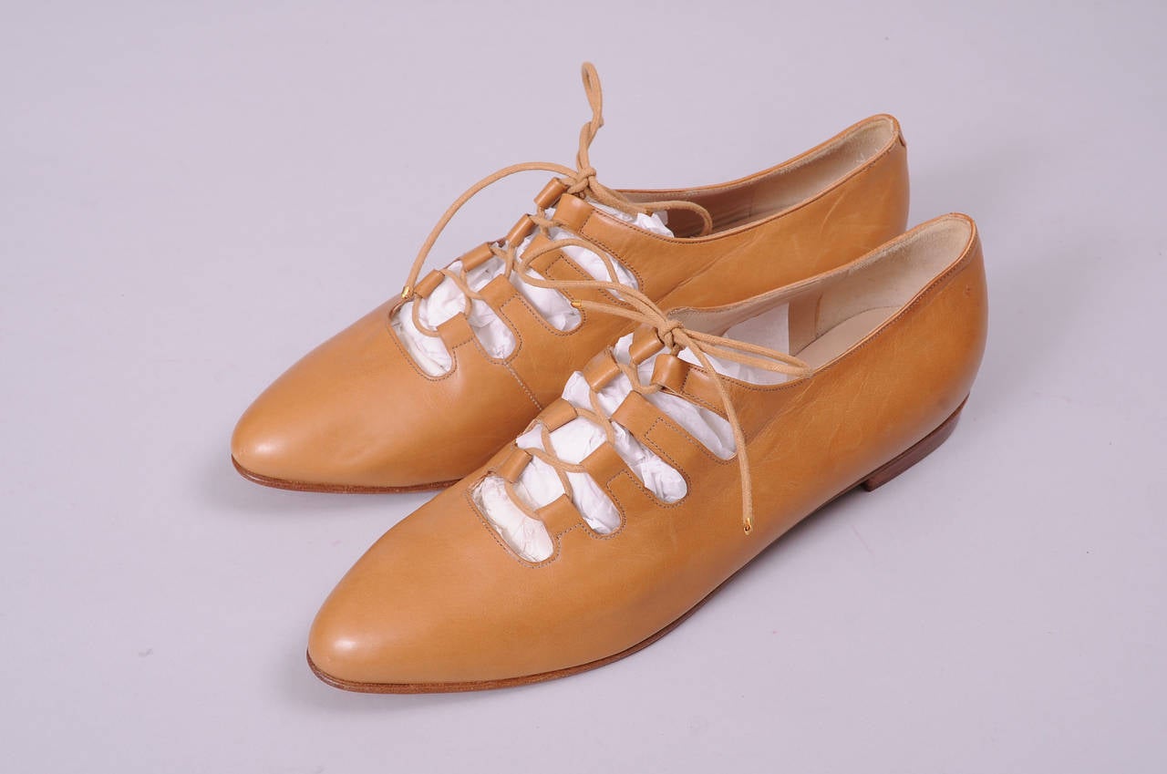 Camel colored leather is used for these lace up flats from Valentino Couture. The shoes are lined in leather and bear the couture label. They have never been worn and they are in excellent condition. They are marked a size 10.