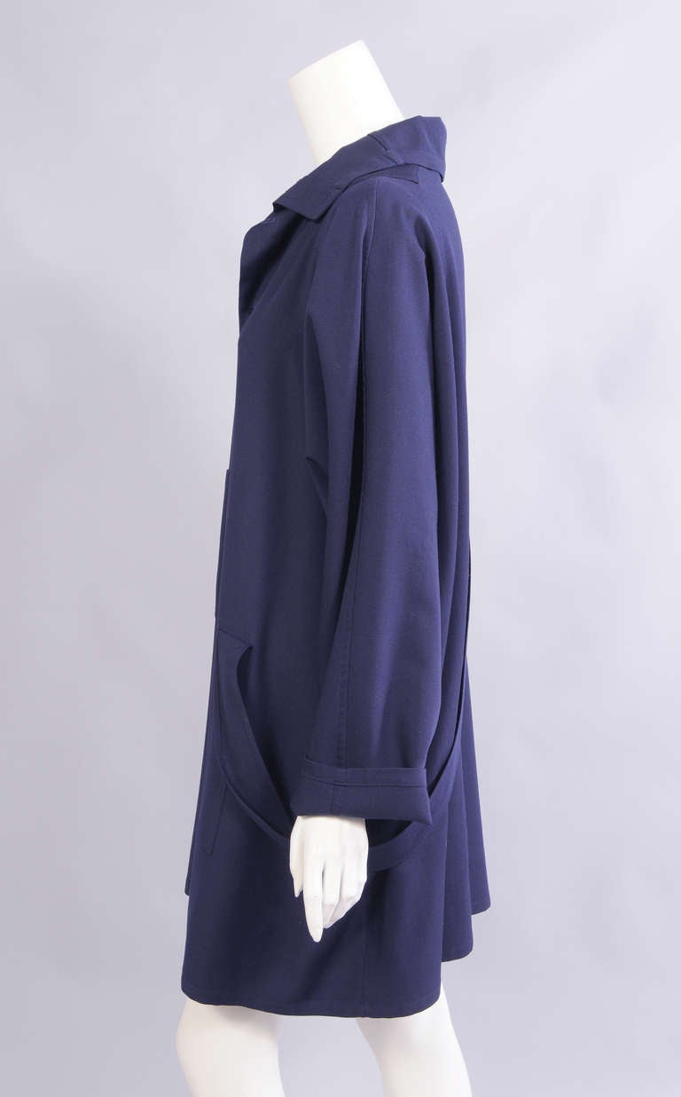 Light weight navy blue wool is used for this button front shirt or dress. There is a large patch pocket on the right side and a half belt on the left side. It is in excellent condition and marked a size Medium.