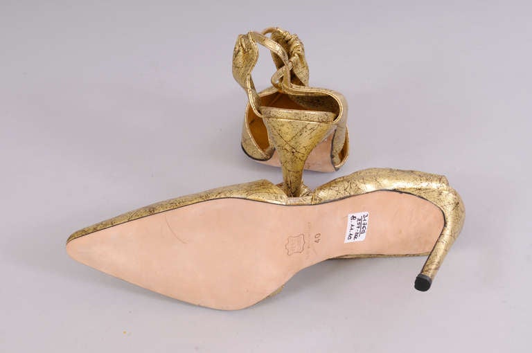 A fabulous gold kidskin is patterned to look like marble with delicate veining throughout. The shoes slip on with three elasticized panels. The heel is high and narrow and they have never been worn. They are in pristine condition and marked a size