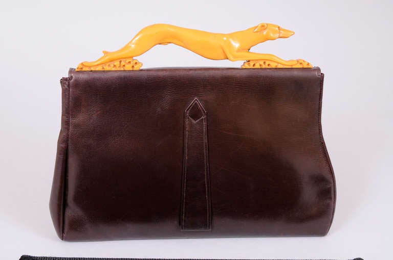 clutch with a distinctive bakelite handle shaped like a running greyhound.