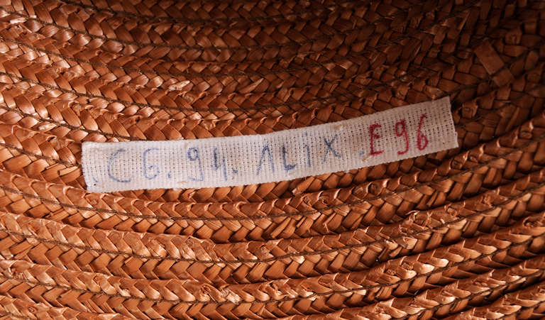 Designed for the Ete 96, or summer Haute Couture collection in 1996, this large mocha colored straw hat is guaranteed to get you noticed while it protects you from the sun. A rigid weave in the straw adds interest. It bears the couture runway label