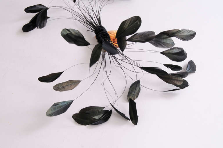 This elegant hair ornament from Givenchy Haute Couture has fanciful feathers that are wrapped with black velvet and secured to a tortoise look hair comb. It is in pristine, unworn condition.
Measurements;
Height 10