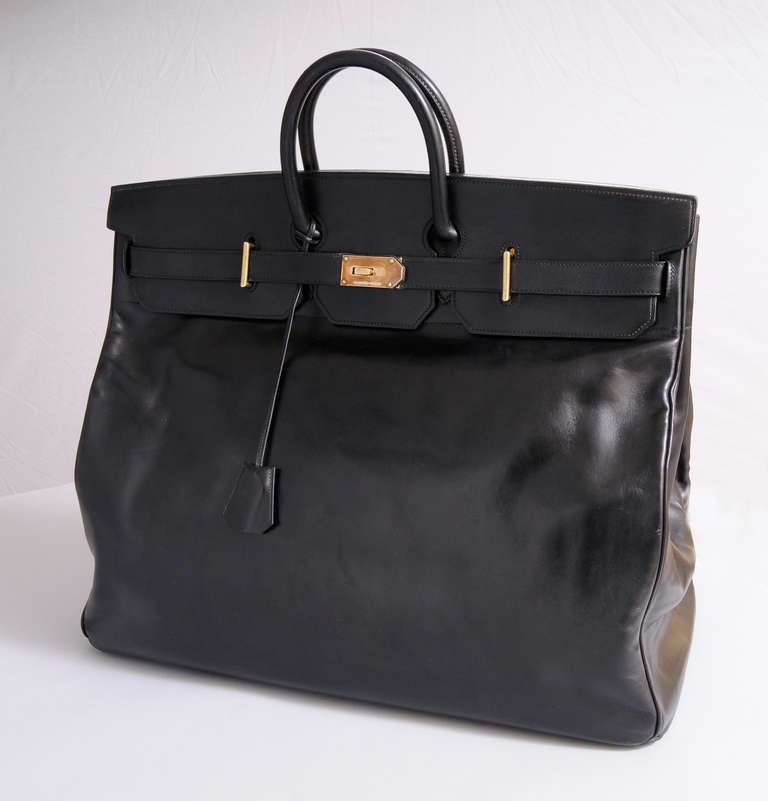 Truly a rare find, Hermes no longer makes the HAC bag in this large size. Originally designed to carry riding gear it is perfect for a weekend getaway. The black calfskin bag has the traditional hardware, also used on the later Birkin bag. The