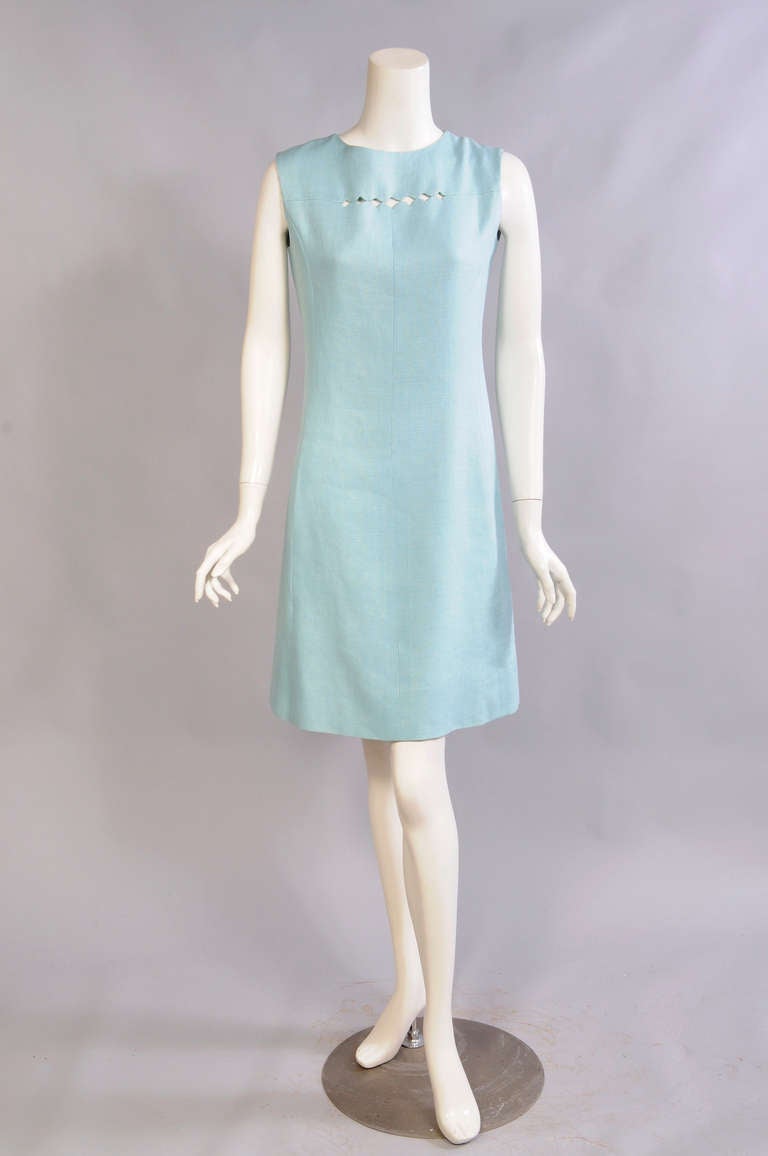 A great shade of blue, an elegant little cut out on the bodice, and a sleek shape
all combine to make a very wearable summer dress. Retailed by Bonwit Teller the dress has a center back zipper and it is fully lined. It is in excellent