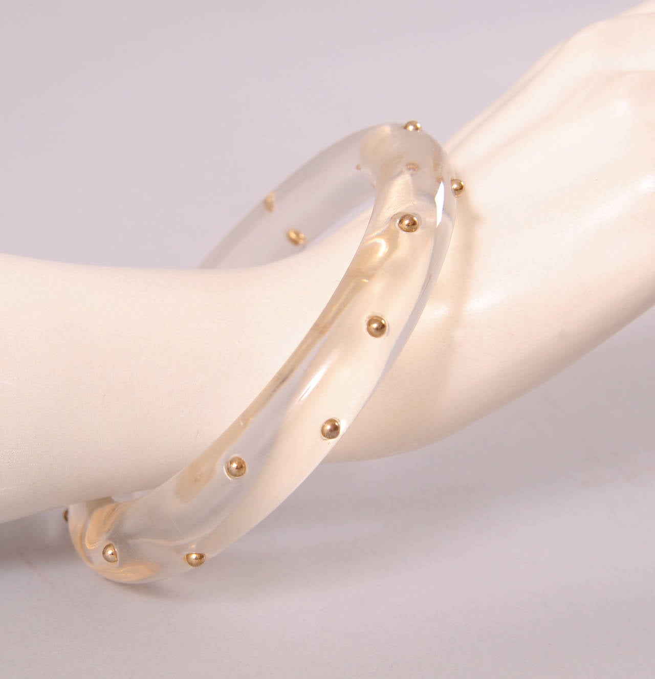 Clear Lucite is studded with real gold beads creating a great and rare juxtaposition of these materials. The bracelet is in excellent condition.
Measurements;
Height 5/8