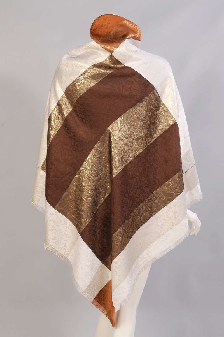 This versatile silk shawl can be worn in three different color ways. All of these colors have metallic gold bands woven through for added glamour. Never used, it is in excellent condition.
 Measurements;
Length 52